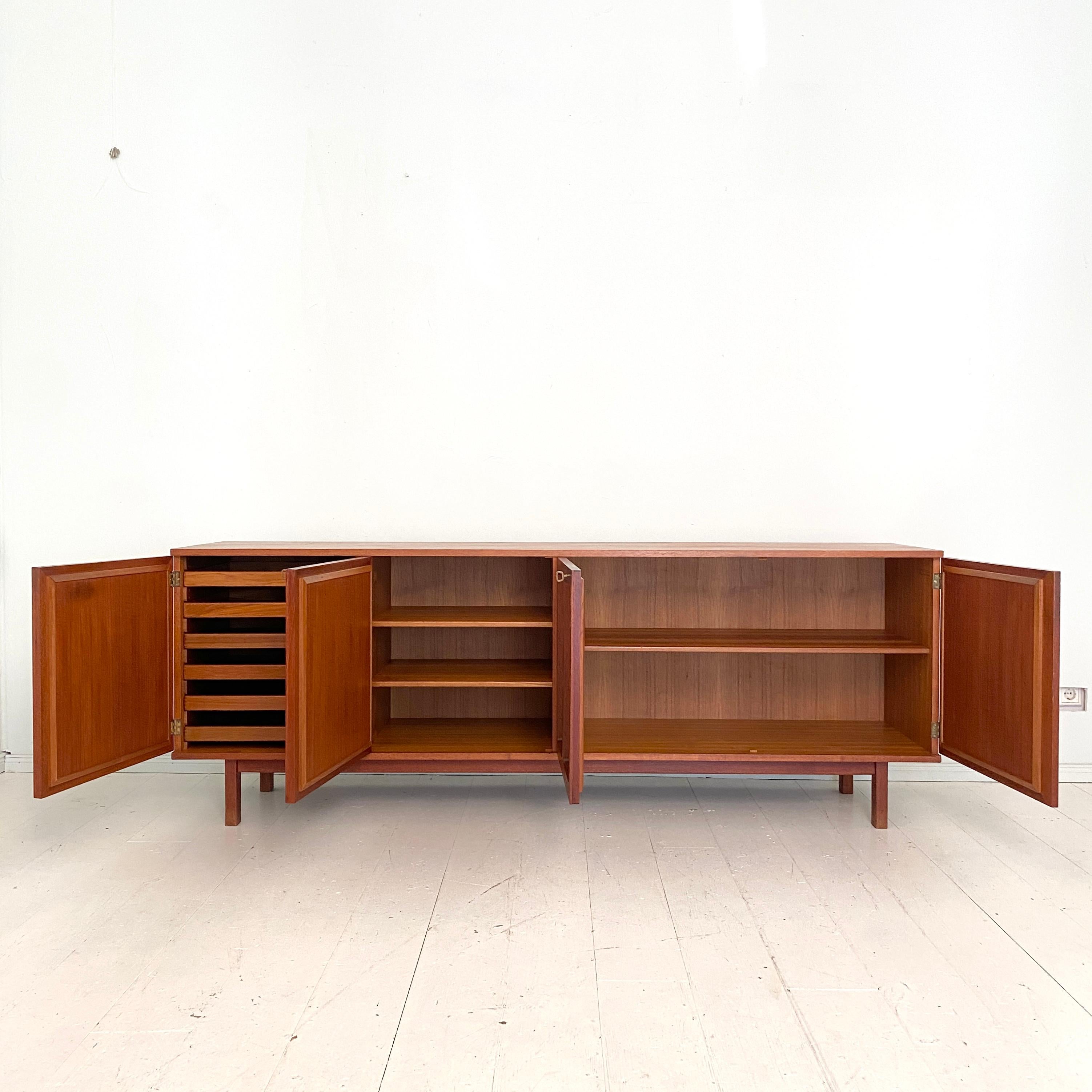 This beautiful mid century teak sideboard by Karl-Erik Ekselius for JOC was made 1964.
It is marked and signed, also done by the 19th March 1964.
The sideboard has got our doors and one is hiding 6 tablet drawers. It is made from fantastic quality