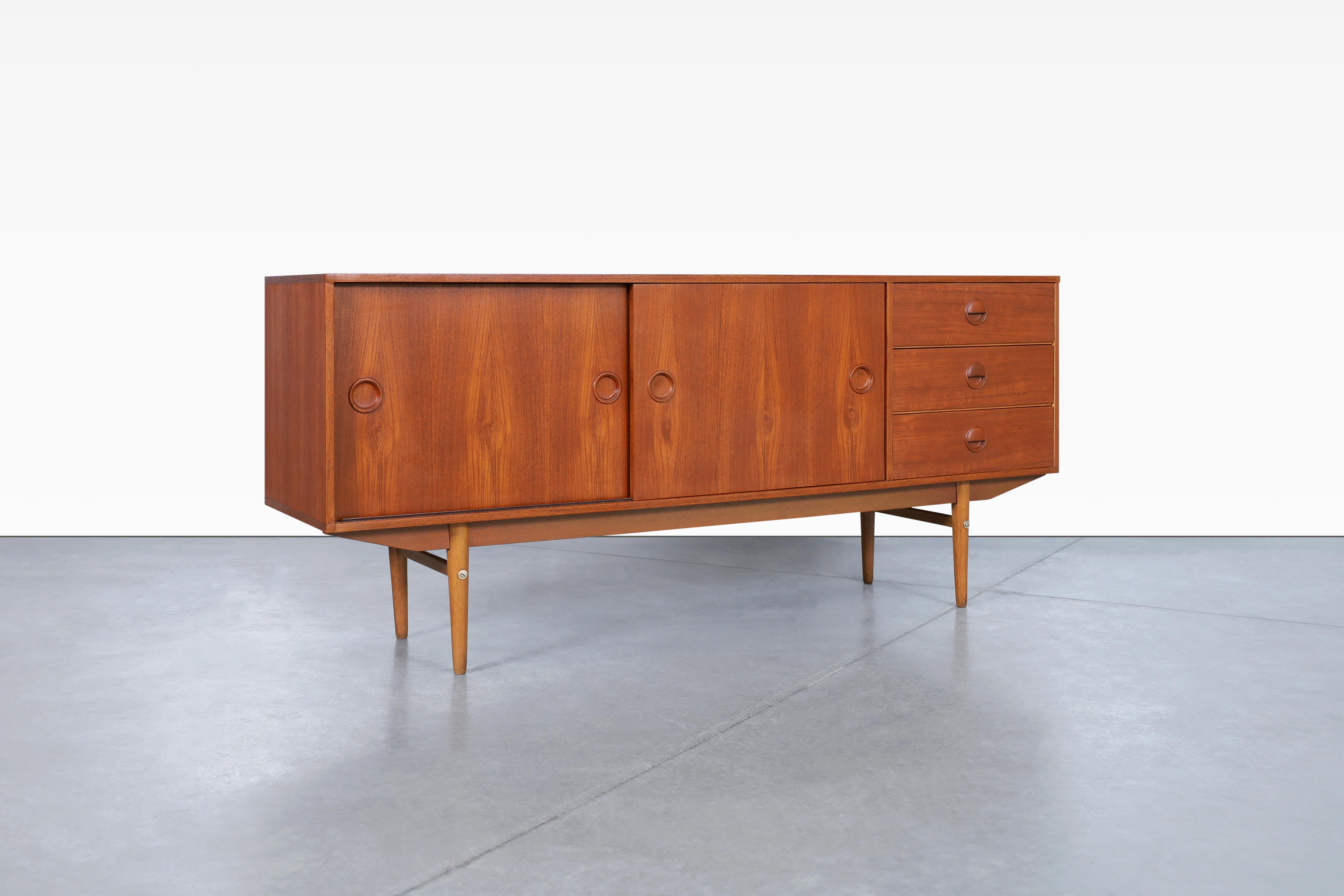 Fabulous mid-century teak sideboard by Marten Francken for Fristho in Netherland, circa 1960s. Crafted with meticulous attention to detail, this sideboard exemplifies the impeccable craftsmanship of the era. The handcrafted handles, shaped with
