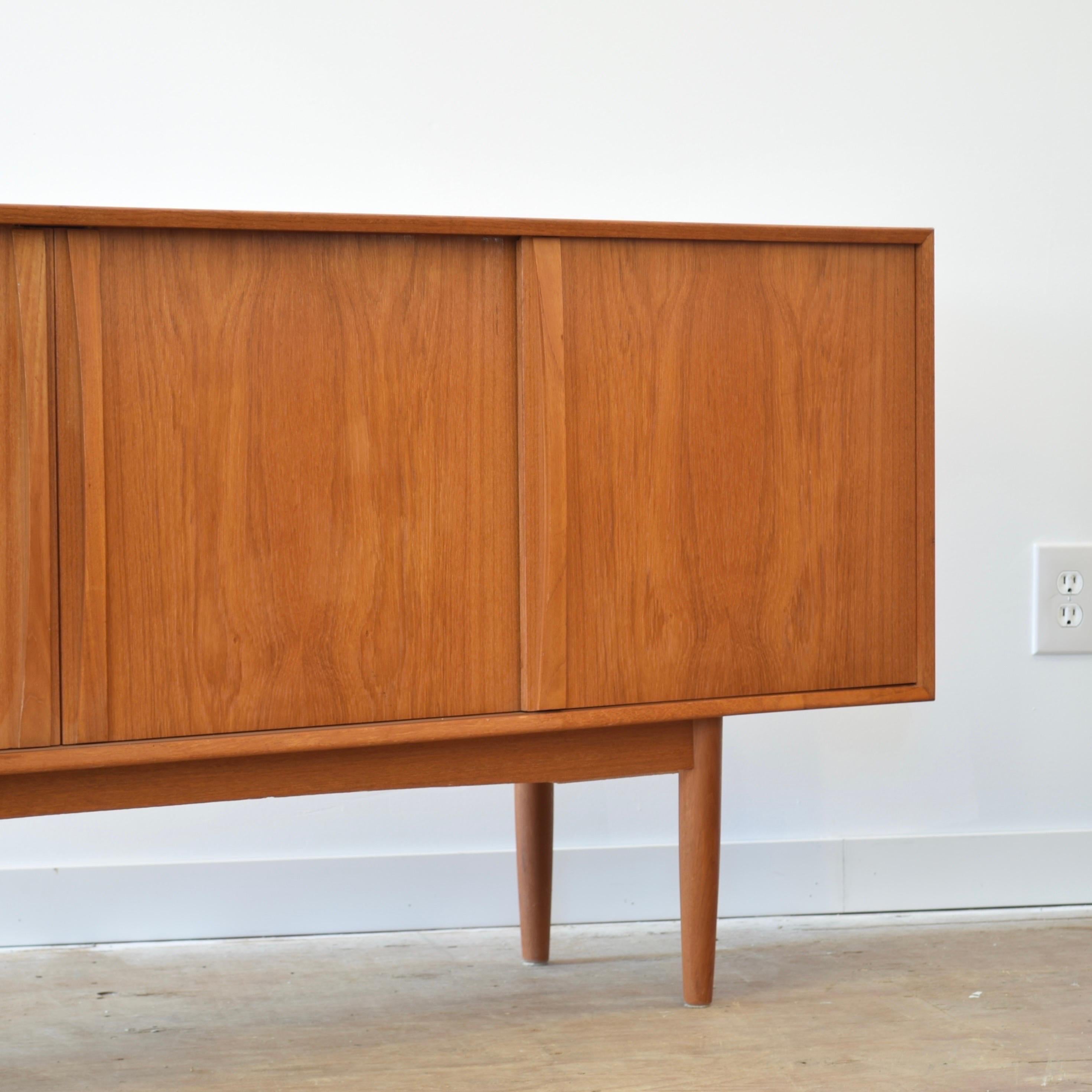 Condition: Great Vintage Condition

Dimensions: 76.75” L x 15.75” D x 31” H

Description: A vintage Danish teak sideboard. Made in Denmark by STM Møbler, circa 1960s. Shelves are adjustable. Drawers and doors slide easily and fully. A few minor