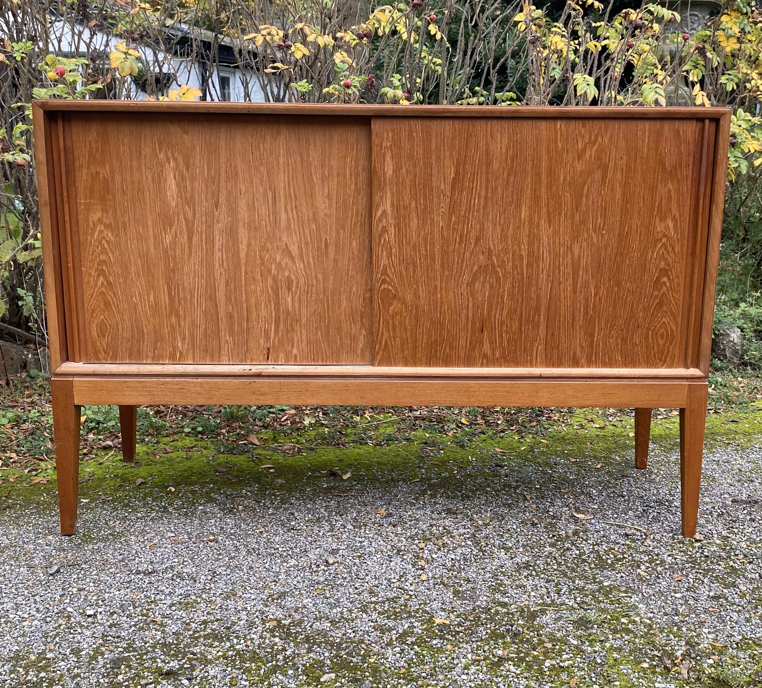 Superb mid century teak Sideboard made by Vanson with sliding doors.  Original finish and good condition with natural signs of age.
British made Vanson furniture was produced by W.G Evans and Sons. It was aimed at the high end of the market with a