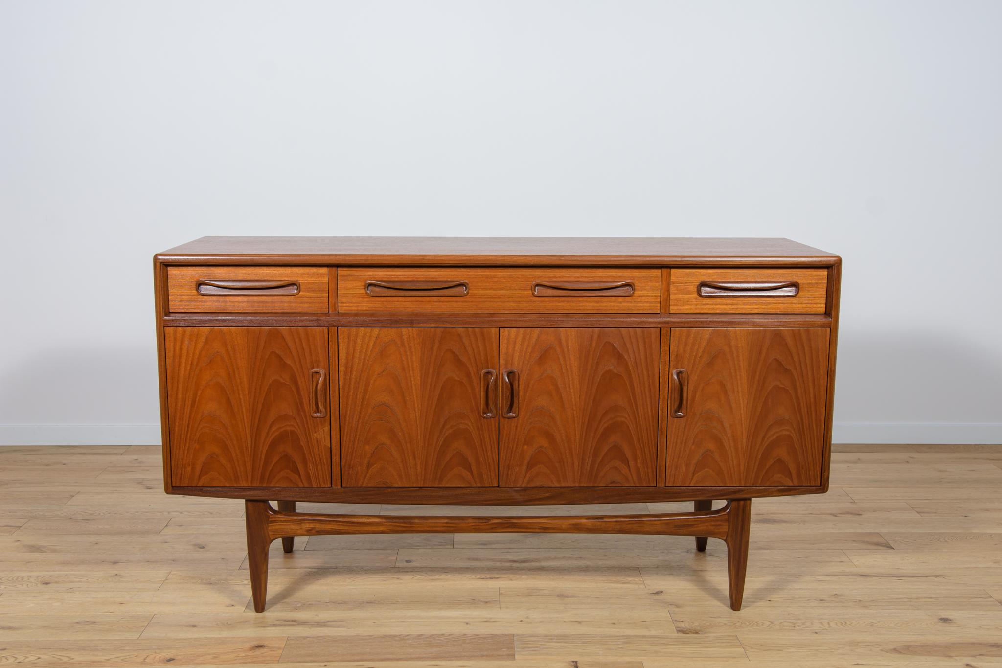 This elegant Scandinavian influenced credenza designed by Victor Wilkins became an instant Classic for G-Plan, it is an exceptionally well-balanced design with dark Afromosia sculpted handles and trim contrasting against the teak veneer. It sits