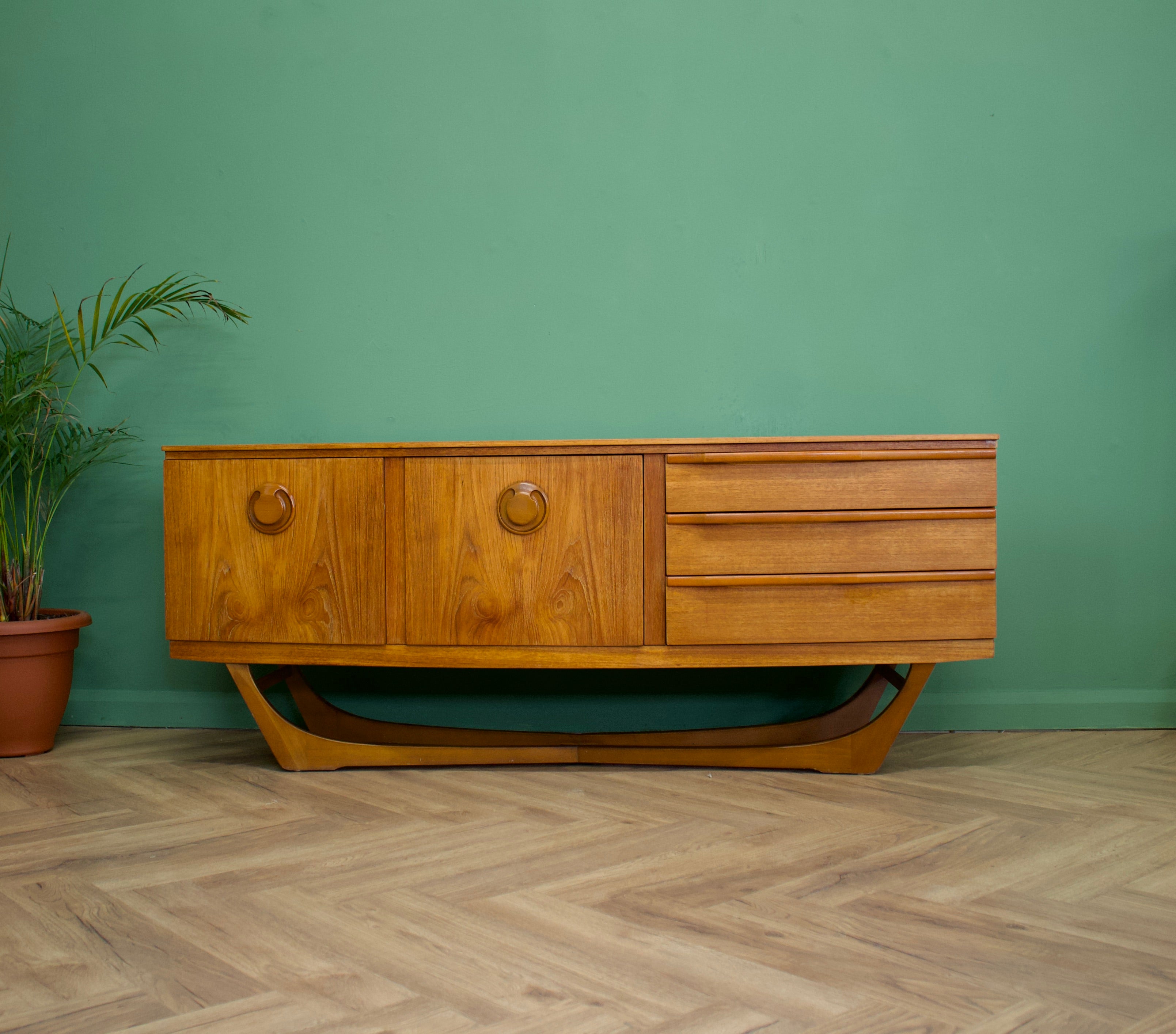 - Mid-Century Modern sideboard.
- Featuring three drawers and two cupboards.
- Manufactured in the UK.
- By Beautility.
- Made from teak and teak veneer.
 