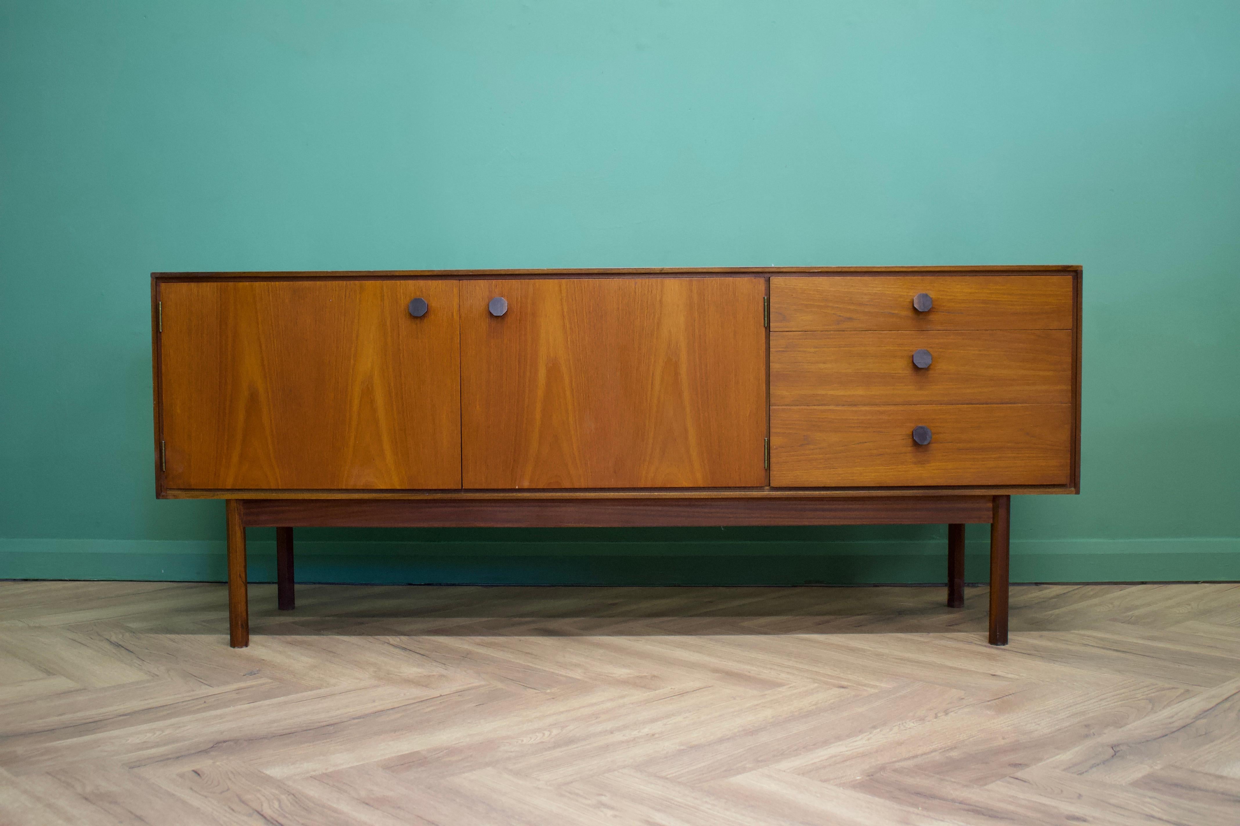 - Mid-Century Modern sideboard.
- Featuring three drawers and a cupboard
- Manufactured in the UK
- By Wrighton 
- Made from teak and teak veneer.