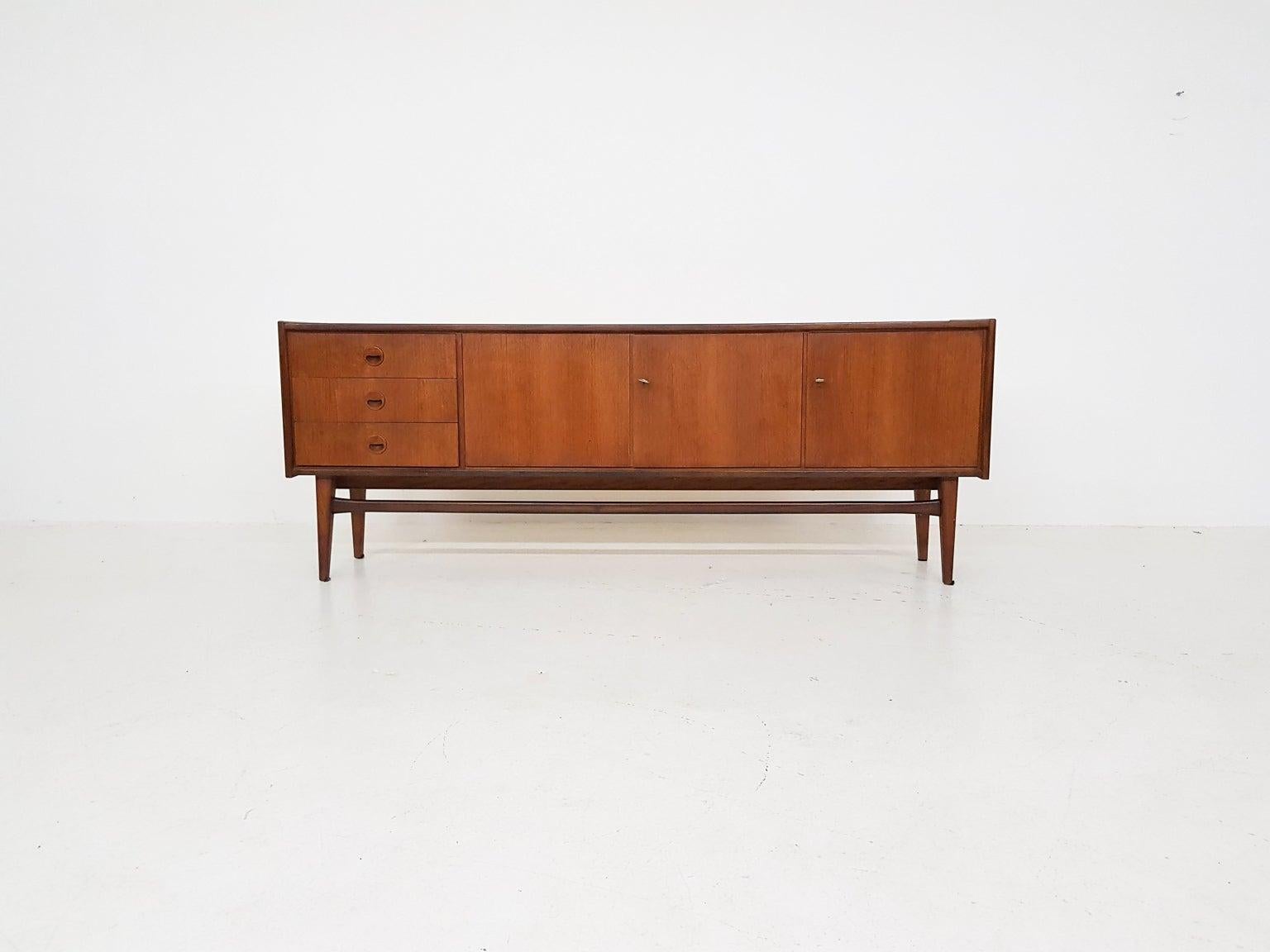 A nice teak and German made sideboard from the midcentury. This sideboard is made by Bartels-Werke in the 1960s and has many resemblances with Danish made sideboards or credenzas of the same time. It has beautiful details like the round, solid teak