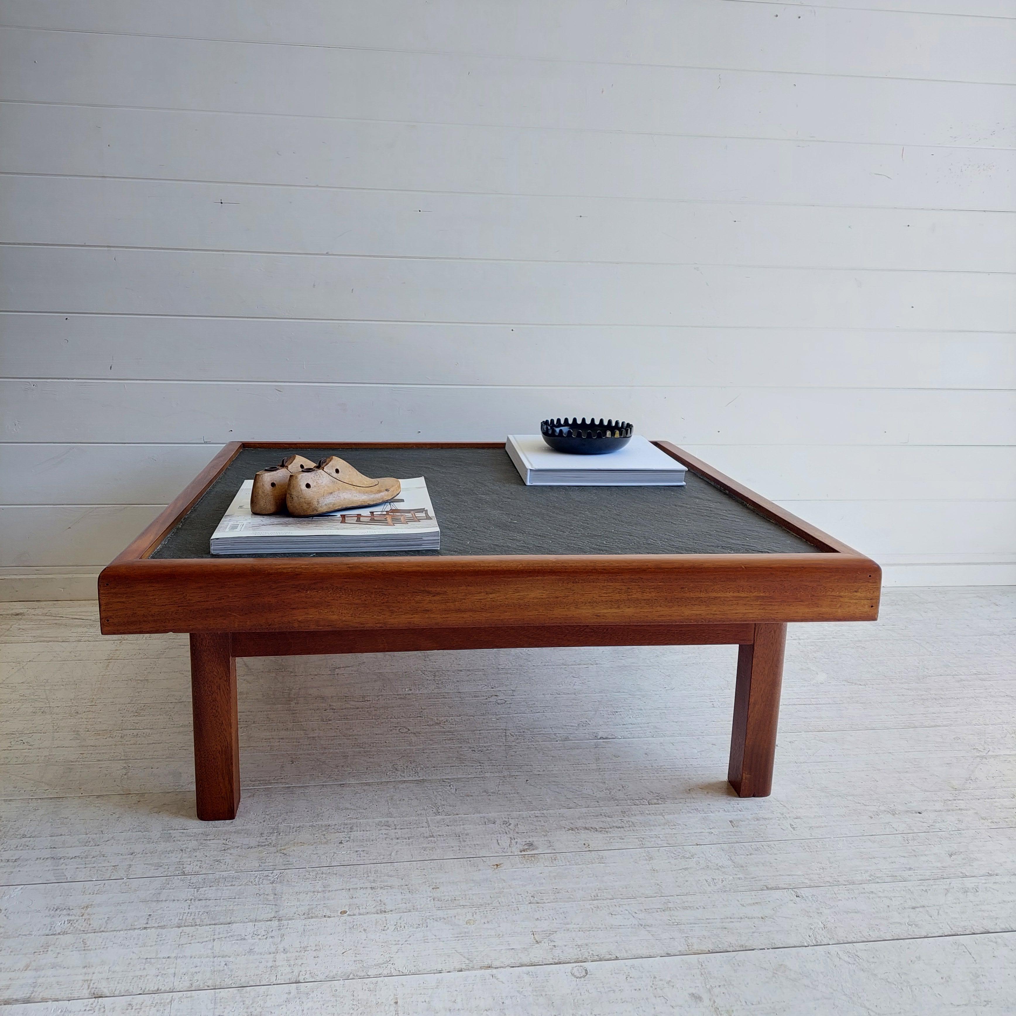 Mid Century Vintage Teak and slate coffee table, 1970

This handmade piece was designed under Pierre Chapo style for Maison Regain around 1970s. 
Also similar to Danish midcentury furniture manufacturers, Bramin. 

The structure of this coffee table