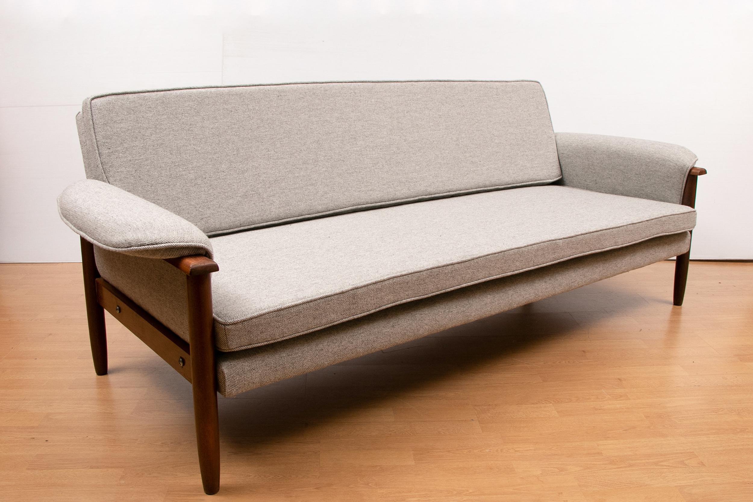 Stunning midcentury teak sofa bed with Kvadrat Hallingdal upholstery, circa 1960s. The sofa bed has been completely refurbished and reupholstered with Kvadrat Hallingdal fabric. 2 legs are screwed to the back of the backrest when used as a bed.