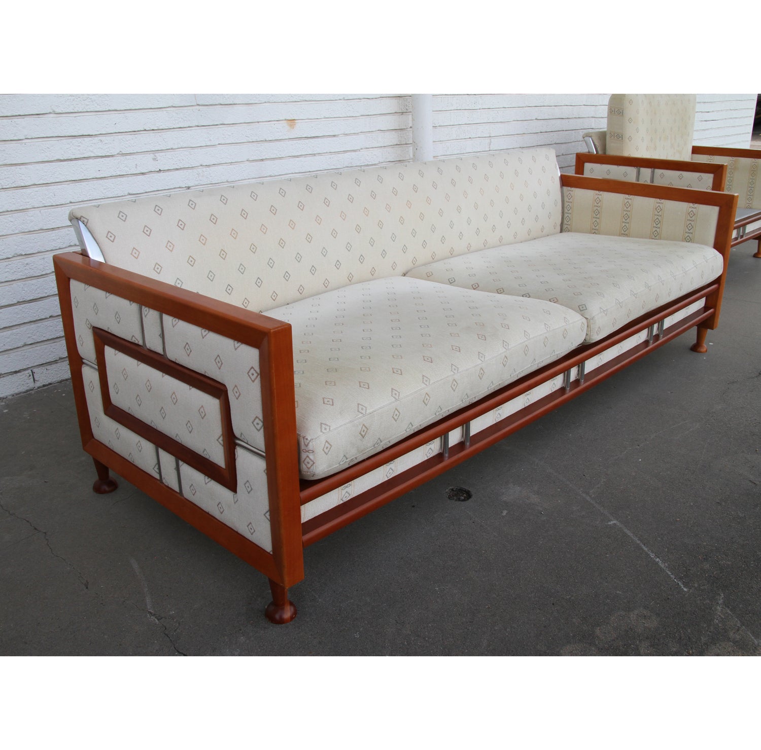 Unique custom teak sofa from Spain.

Interesting sofa with inlay teak and chrome on sides and base. We have matching lounge chairs available as well.

Reupholstery recommended.