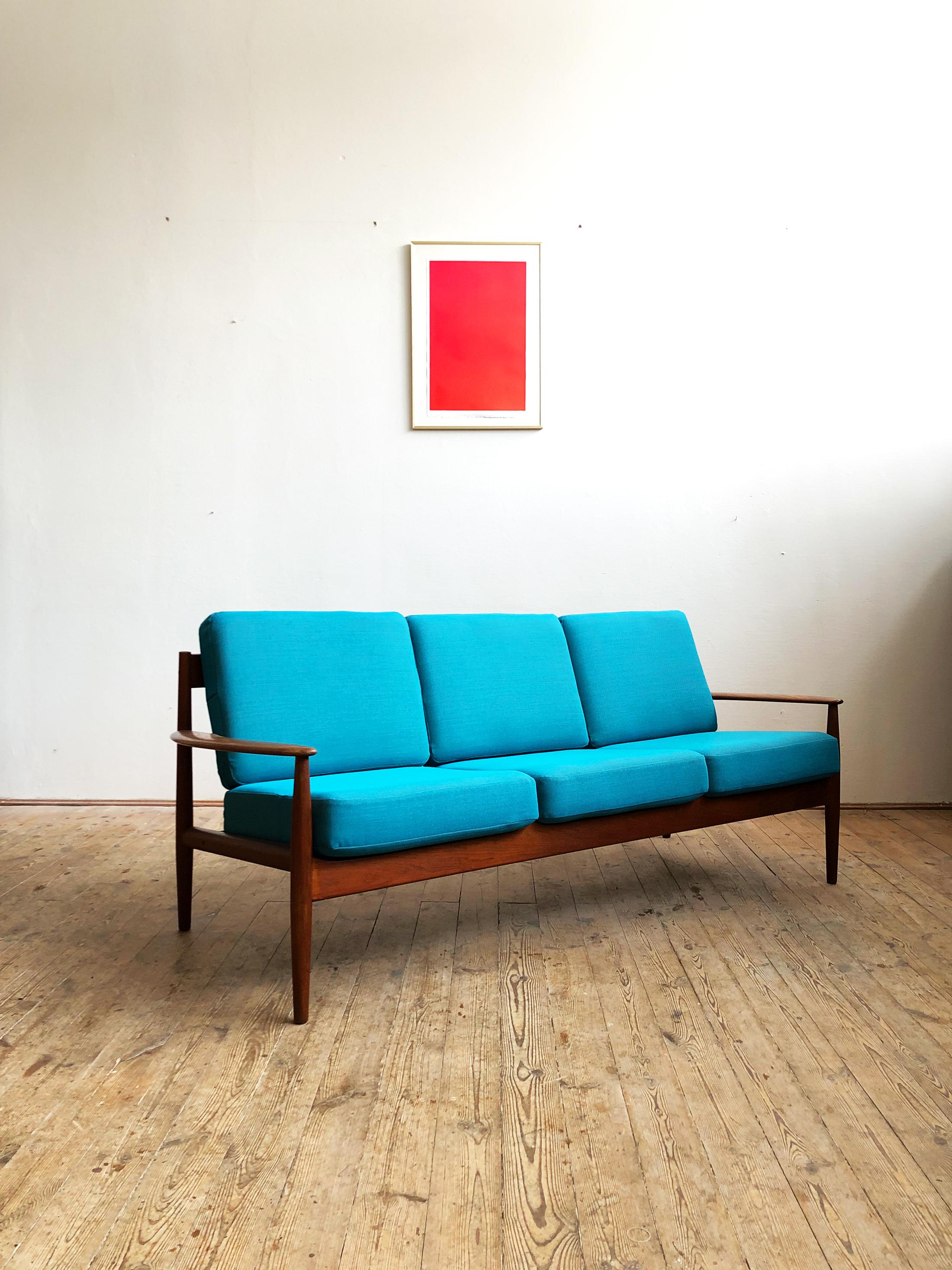 Teak sofa produced by France & Son and designed by Grete Jalk. The Sofa shows best Danish quality craftsmanship. It comes with new tight spring cushions with a new upholstery from Danish premium Manufacturer Kvadrat (Steelcut Trio).