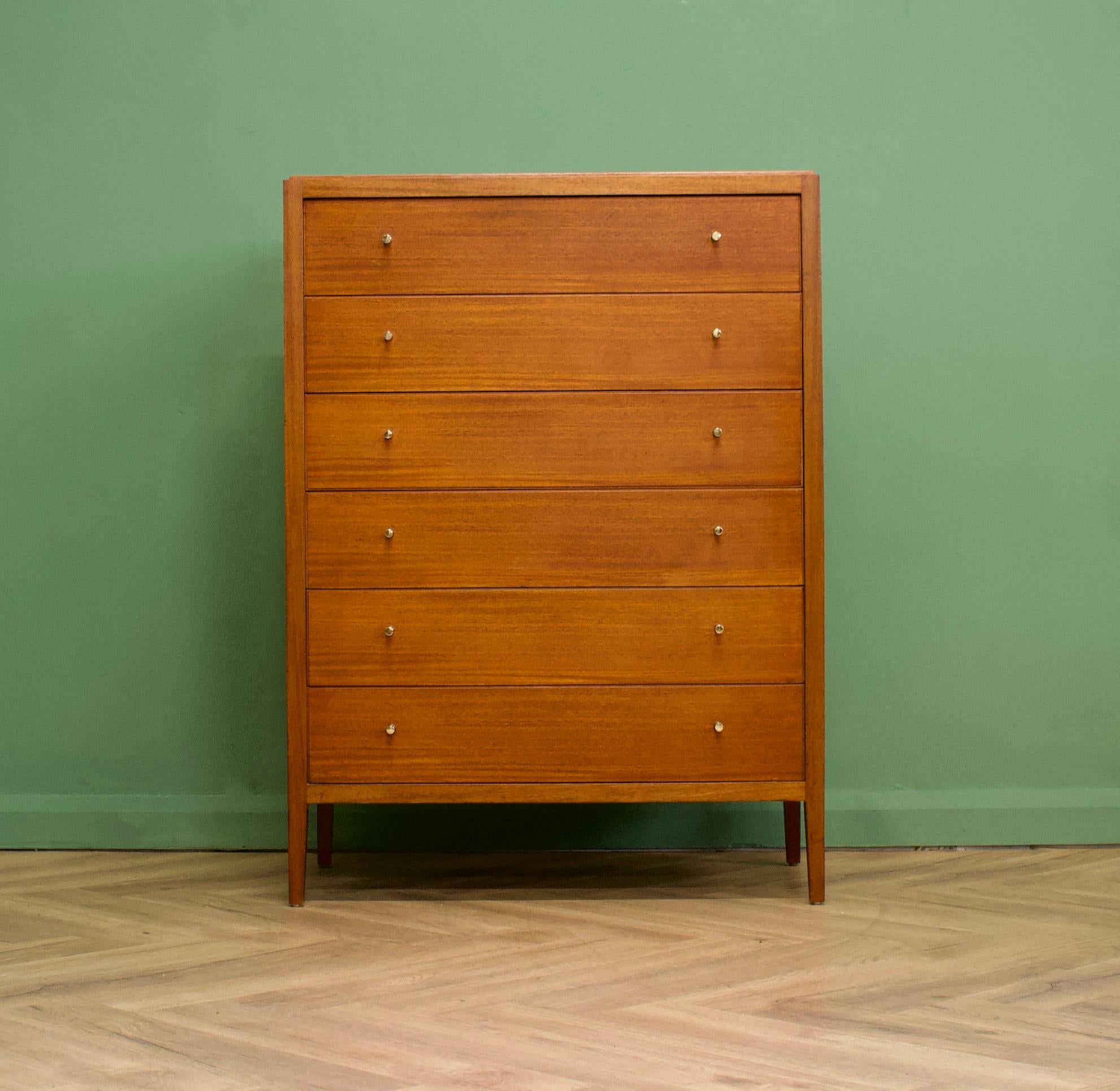 A beautiful quality, mid century mahogany & teak tallboy chest of drawers from Loughborough Furniture - retailed through Heals during the 1950's - early 1960's - and designed by Neville Ward and Frank Austin 
 
Standing on slightly tapered legs,
