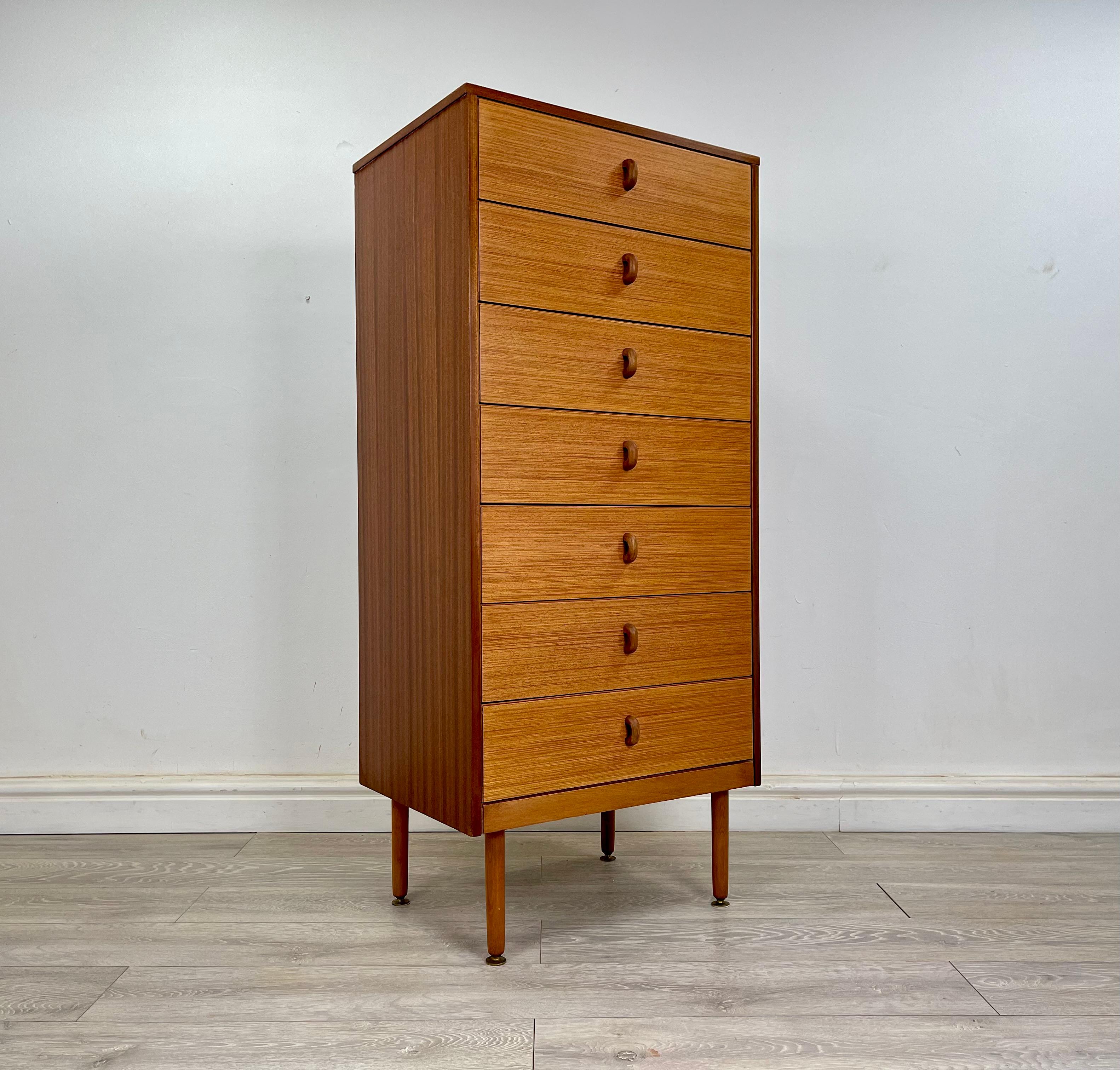 Chest of drawers 
Stunning Midcentury teak tallboy chest of drawers circa 1960 . The chest has stunning grain throughout with contrasting light teak drawer fronts.

The chest stands on long beech legs , there’s seven drawers with solid teak
