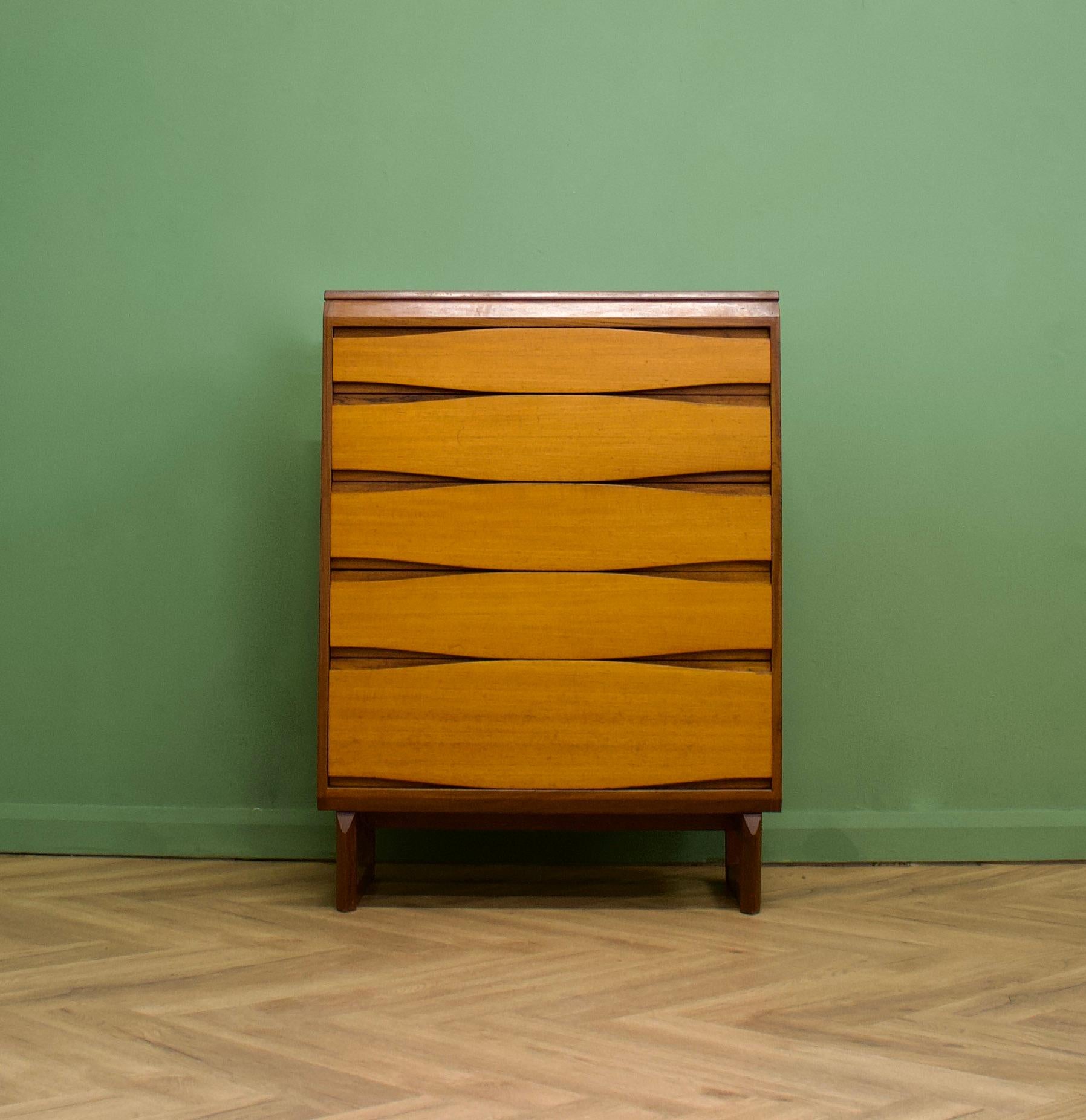 A mid century teak tallboy chest of drawers in the Danish style - circa 1960s - from White & Newton

The piece has a sleek modern look, with its recessed handle design