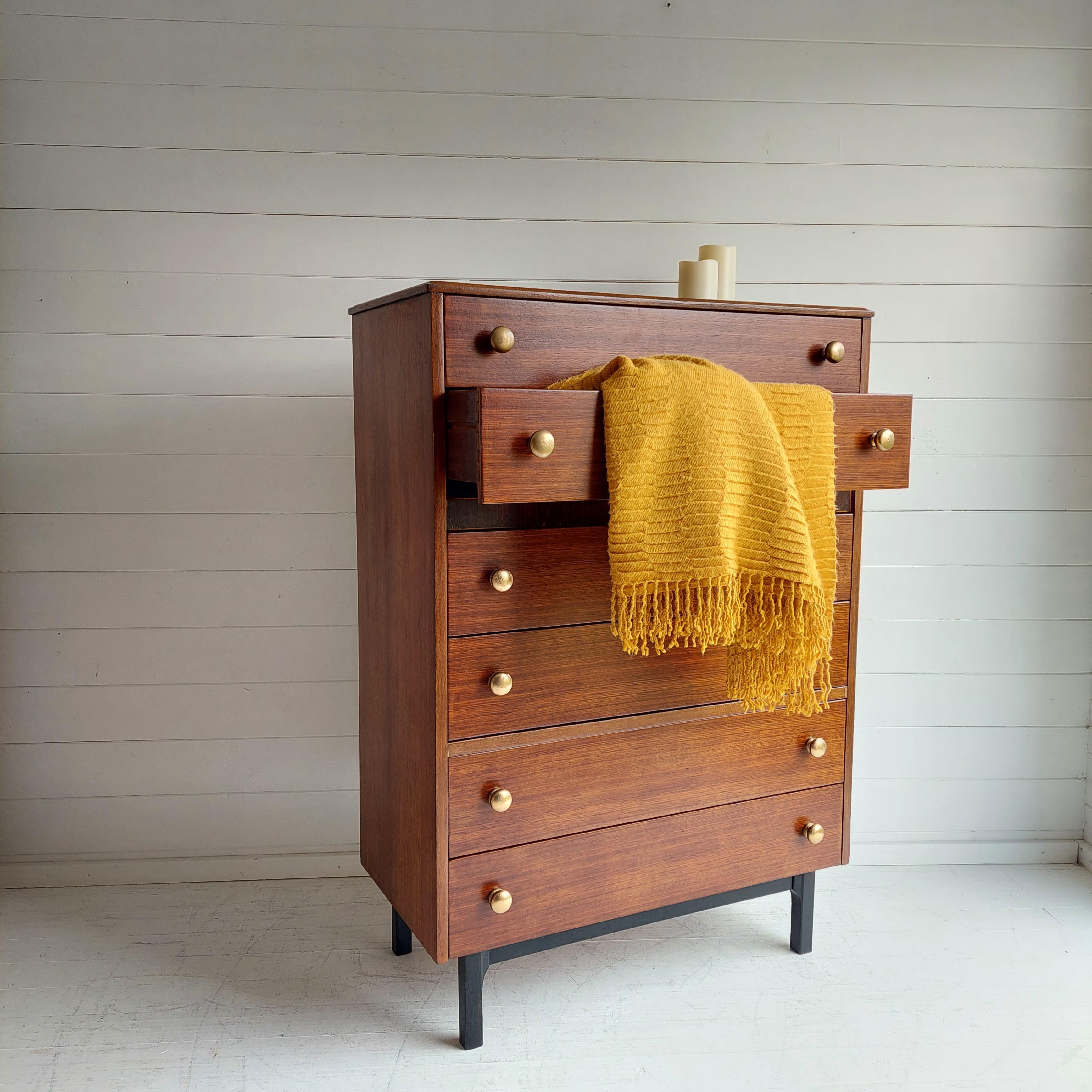 Vintage Danish style teak tallboy / chest of drawers for sale.
Made probably in London by Harris Lebus in the 1960s, this piece is of an outstanding quality and fabulous design.

Retro midcentury tall boy chest of drawers made in teak.