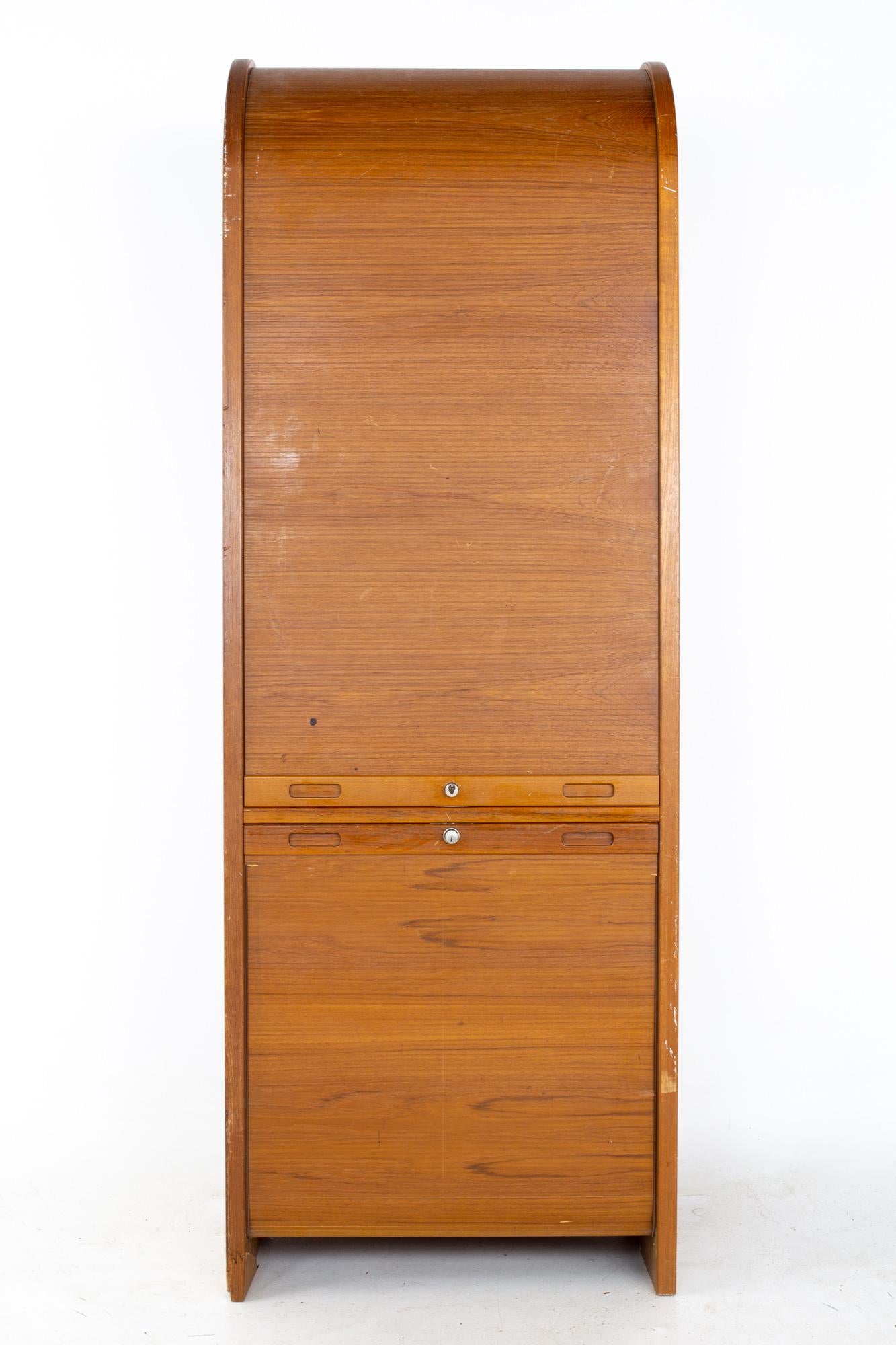 Mid century teak Tambour door upright storage credenza
Credenza measures: 28 wide x 19.75 deep x 79.5 inches high

All pieces of furniture can be had in what we call restored vintage condition. That means the piece is restored upon purchase so