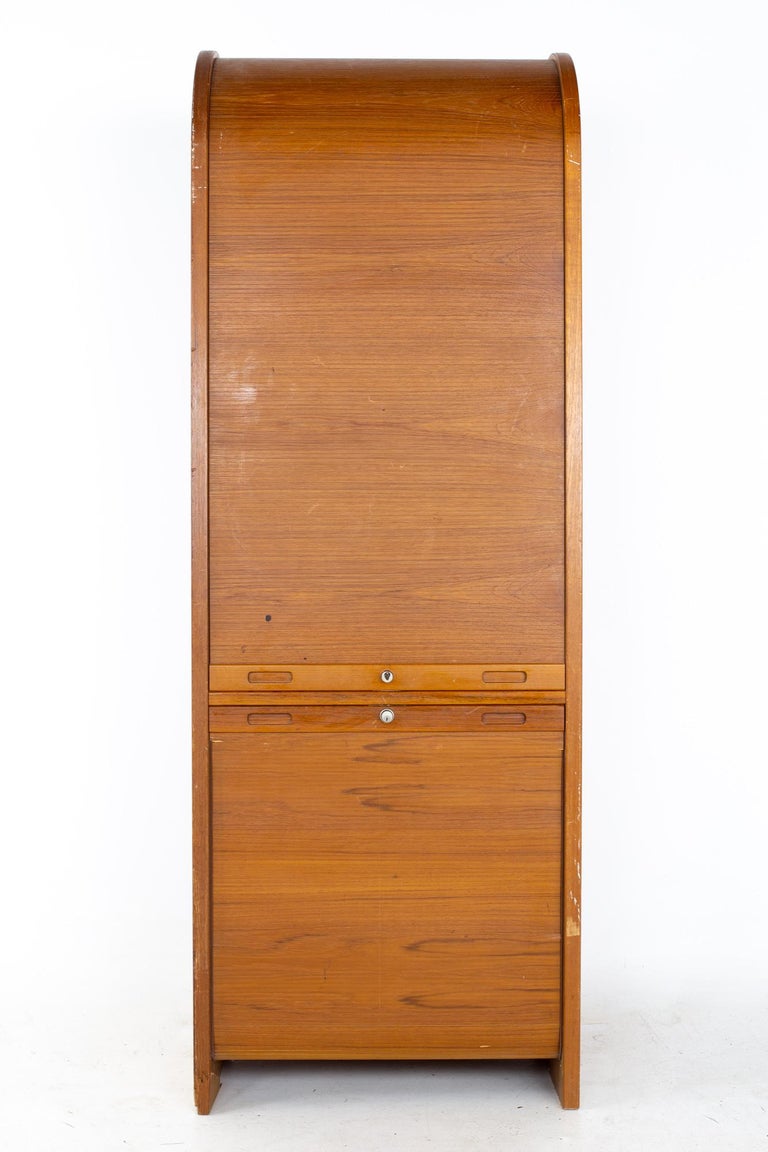 Mid century teak Tambour door upright storage credenza
Credenza measures: 28 wide x 19.75 deep x 79.5 inches high

All pieces of furniture can be had in what we call restored vintage condition. That means the piece is restored upon purchase so