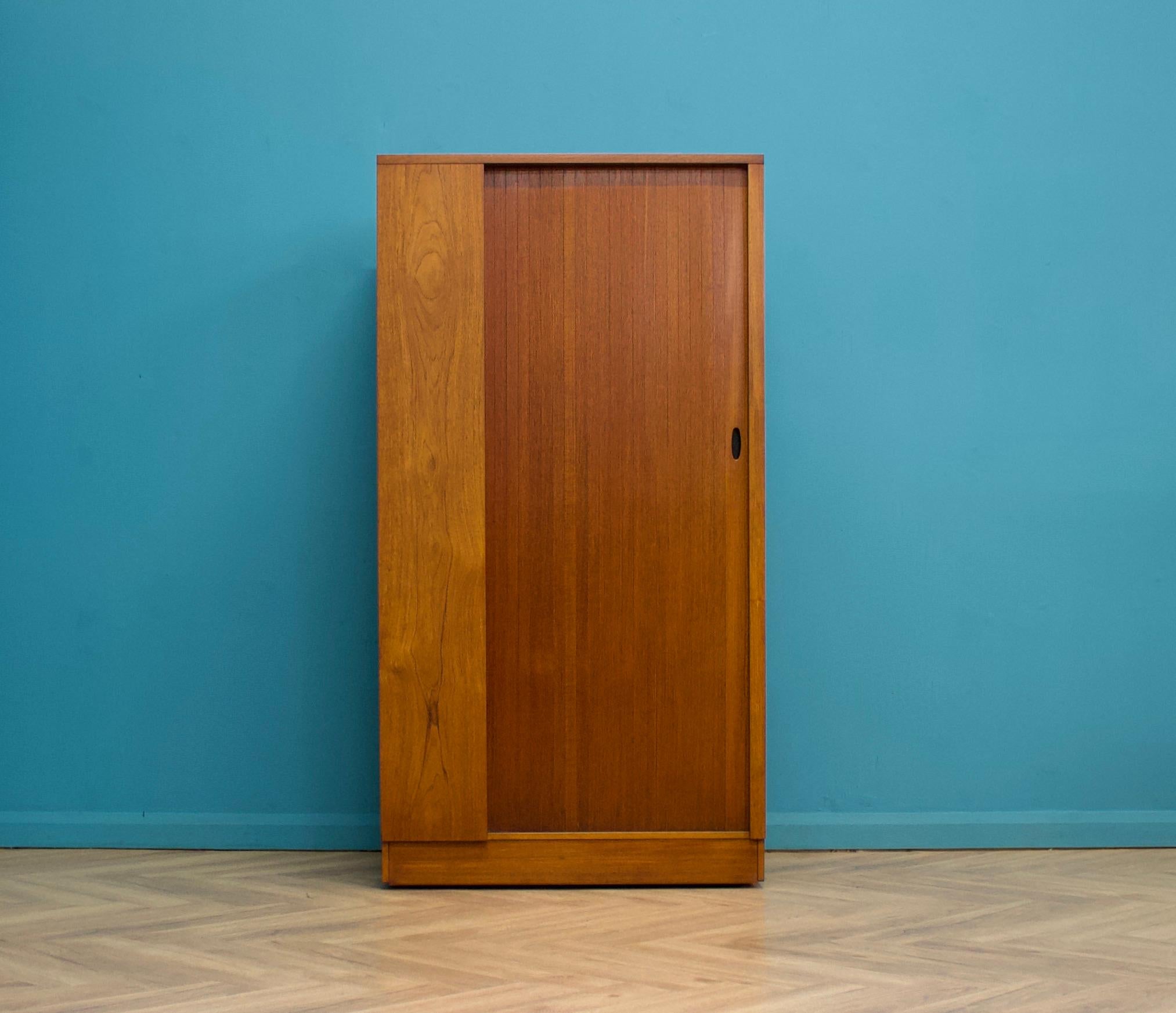 A freestanding teak wardrobe from Austinsuite - standing castors
These Austinsuite wardrobes have a unique design feature of a sliding tambour door - which runs very smooth
Internally there's a hanging rail and shelves
This piece has been cleaned