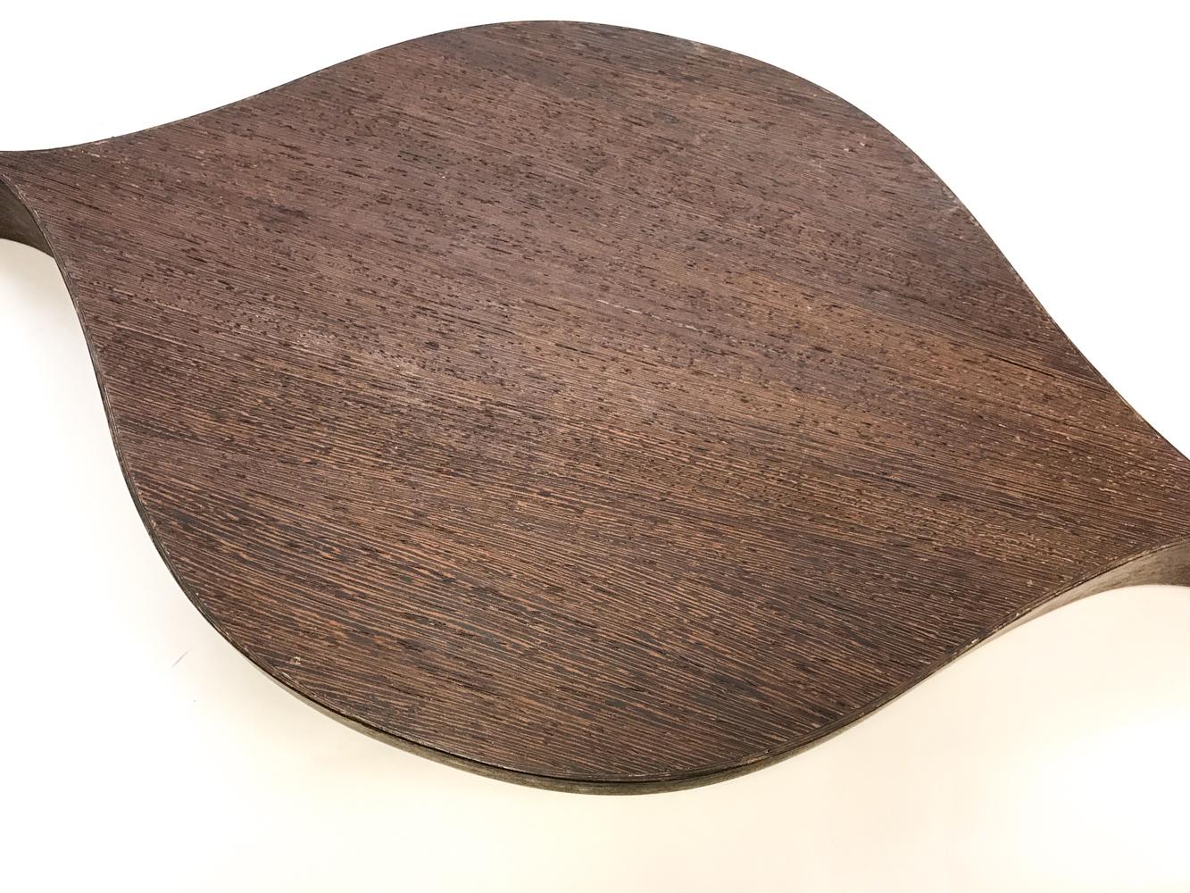 This fantastic midcentury tray features dark stained tropical wood in a tapered marquise or leaf shape, with two long handles and a flat bottom. The matching salad utensils also have long, tapered handles and Minimalist, Viking-inspired design. They
