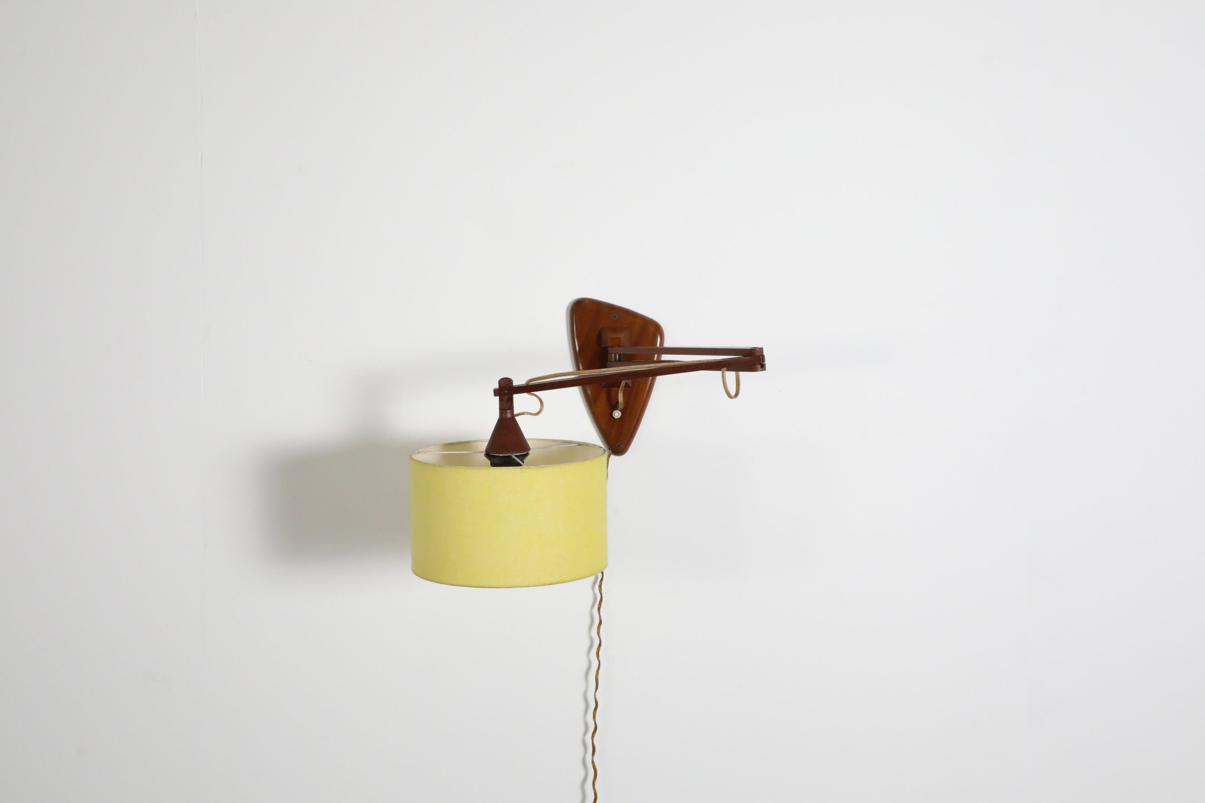 Mid-Century, Teak Wall Lamp with Articulating Arm and Yellow Shade In Good Condition For Sale In Los Angeles, CA