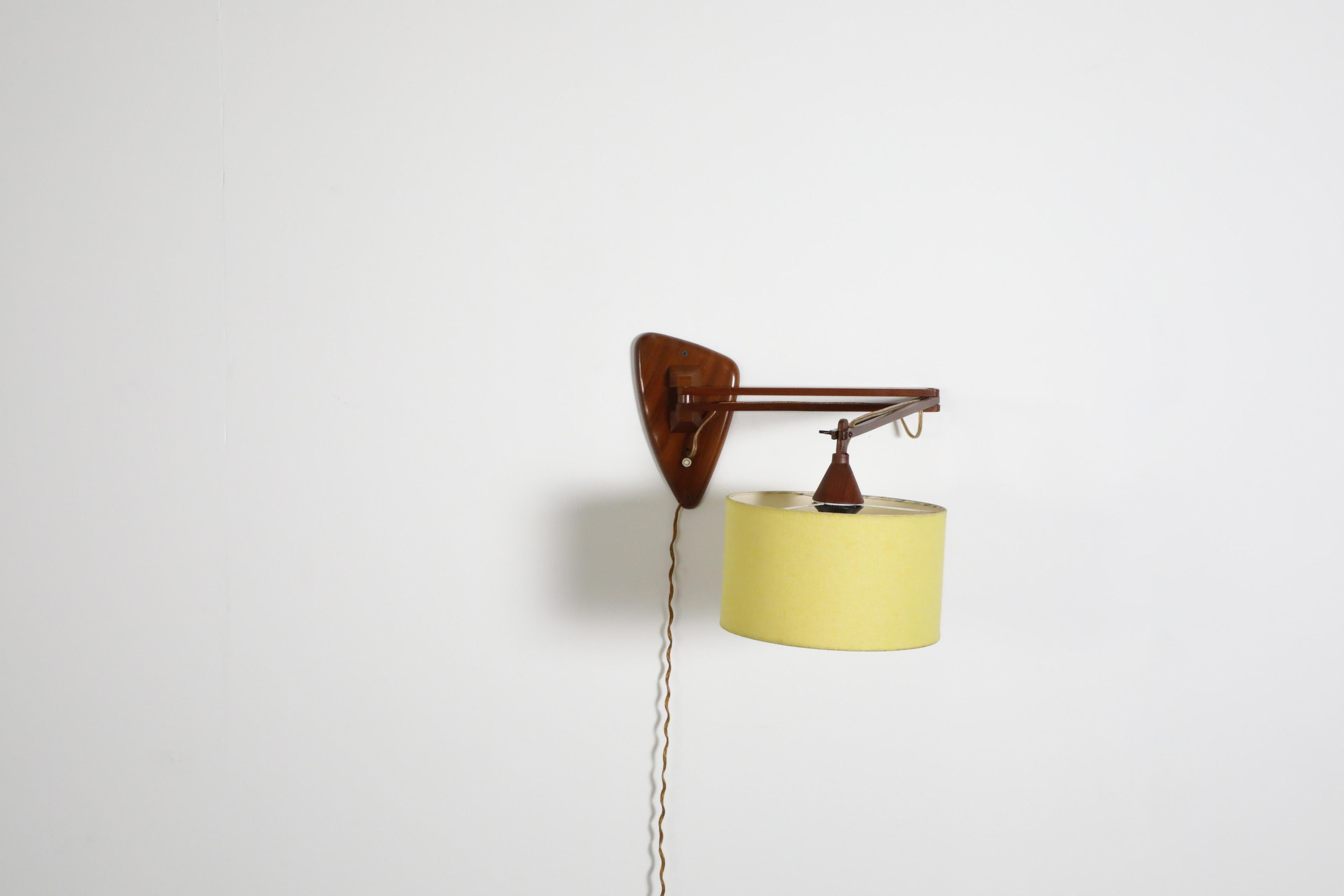 Mid-20th Century Mid-Century, Teak Wall Lamp with Articulating Arm and Yellow Shade For Sale