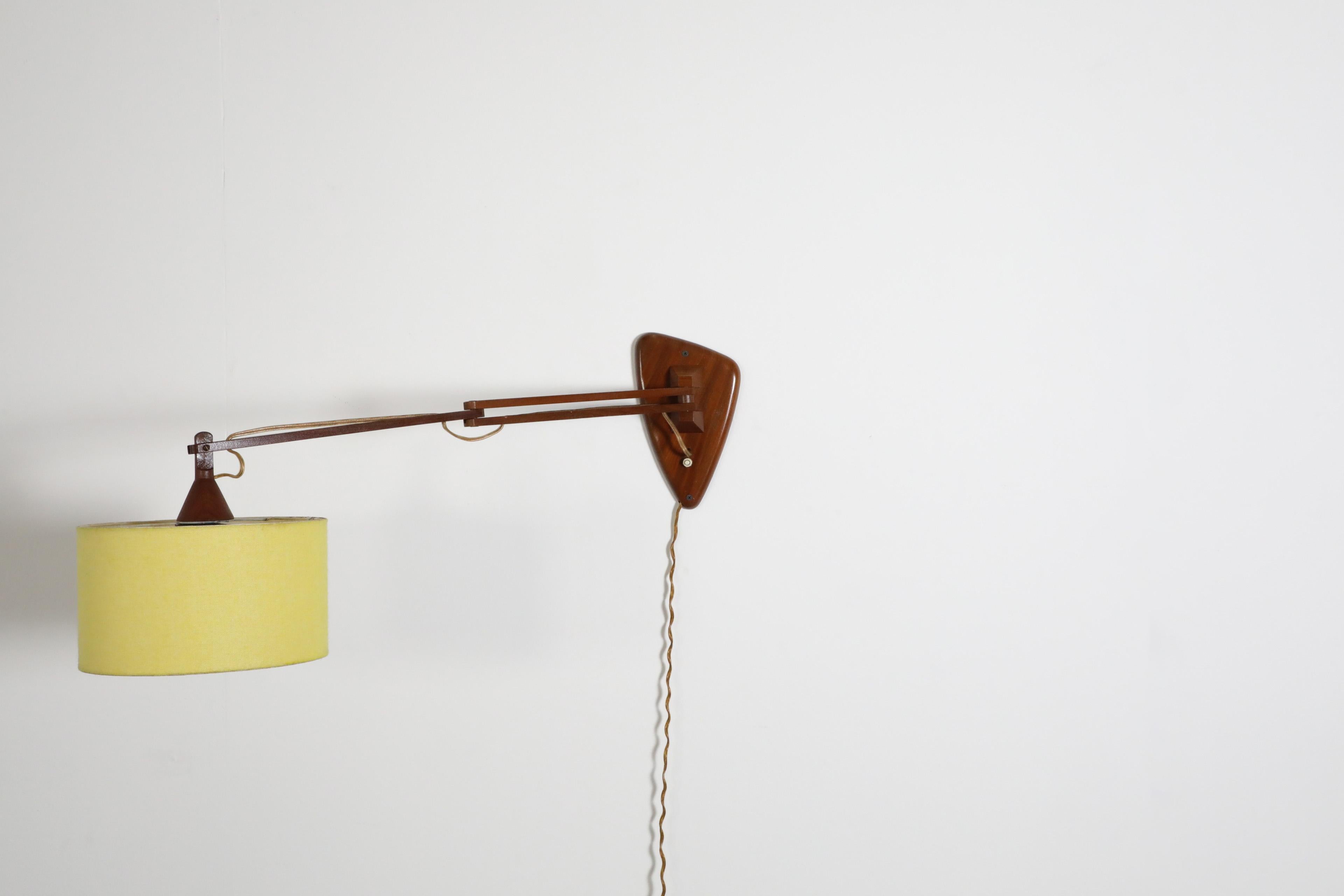 Mid-Century, Teak Wall Lamp with Articulating Arm and Yellow Shade For Sale 1