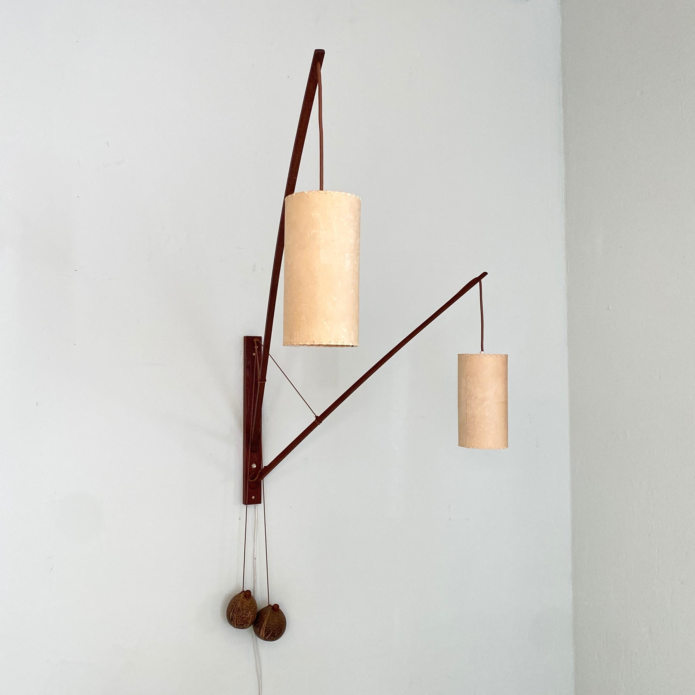 This large and super rare mid century solid teak double wall light by Rupprecht Skrip (Germany) was made in the 1950s. The wall lamp has a solid teak base, two ball-joints with two teak rods of different length, two coconut counterweights which