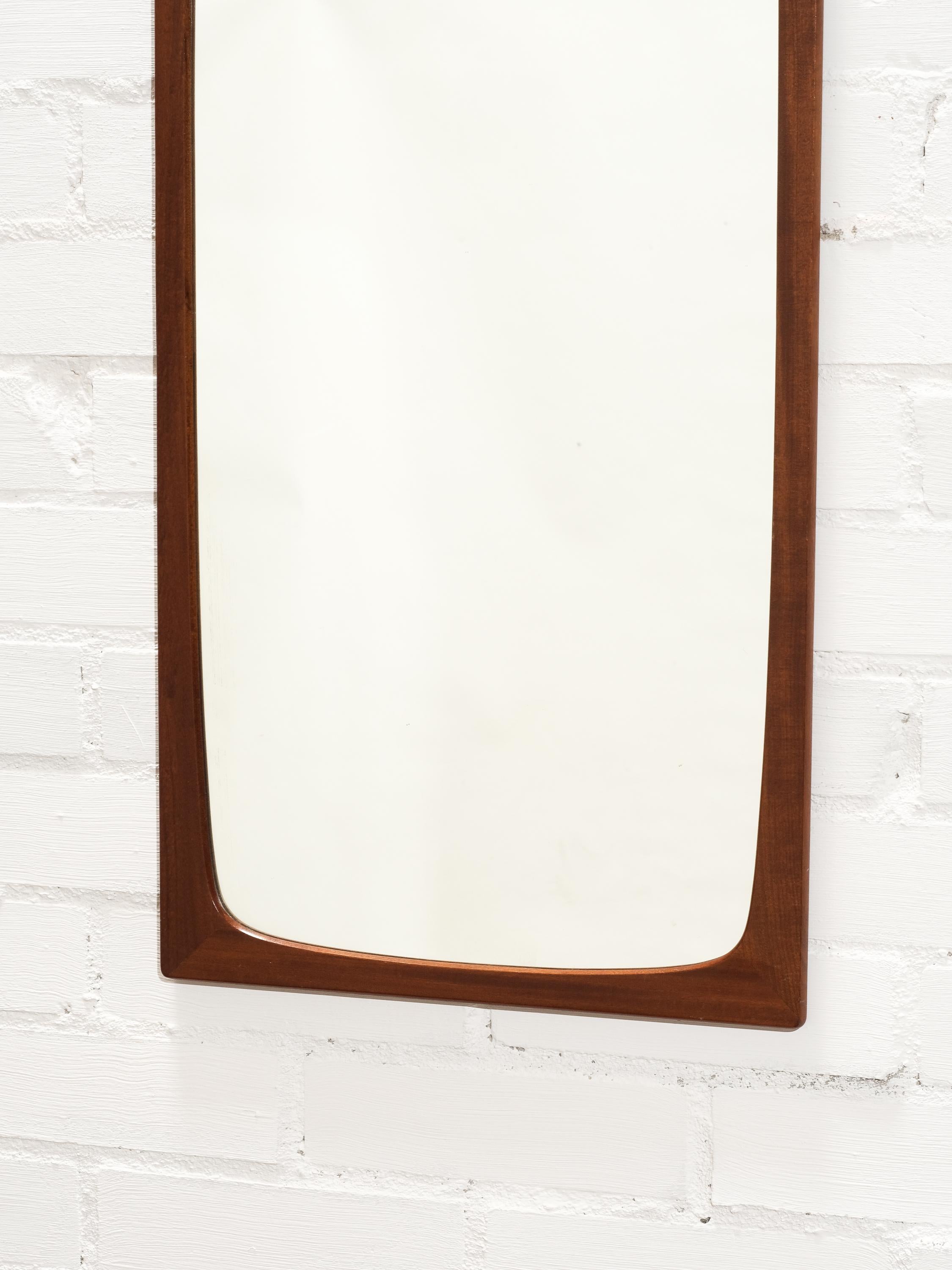 A solid teak wall mirror designed and produced Glas & Trä, Hovmantorp Sweden, 1950s-1960s.
