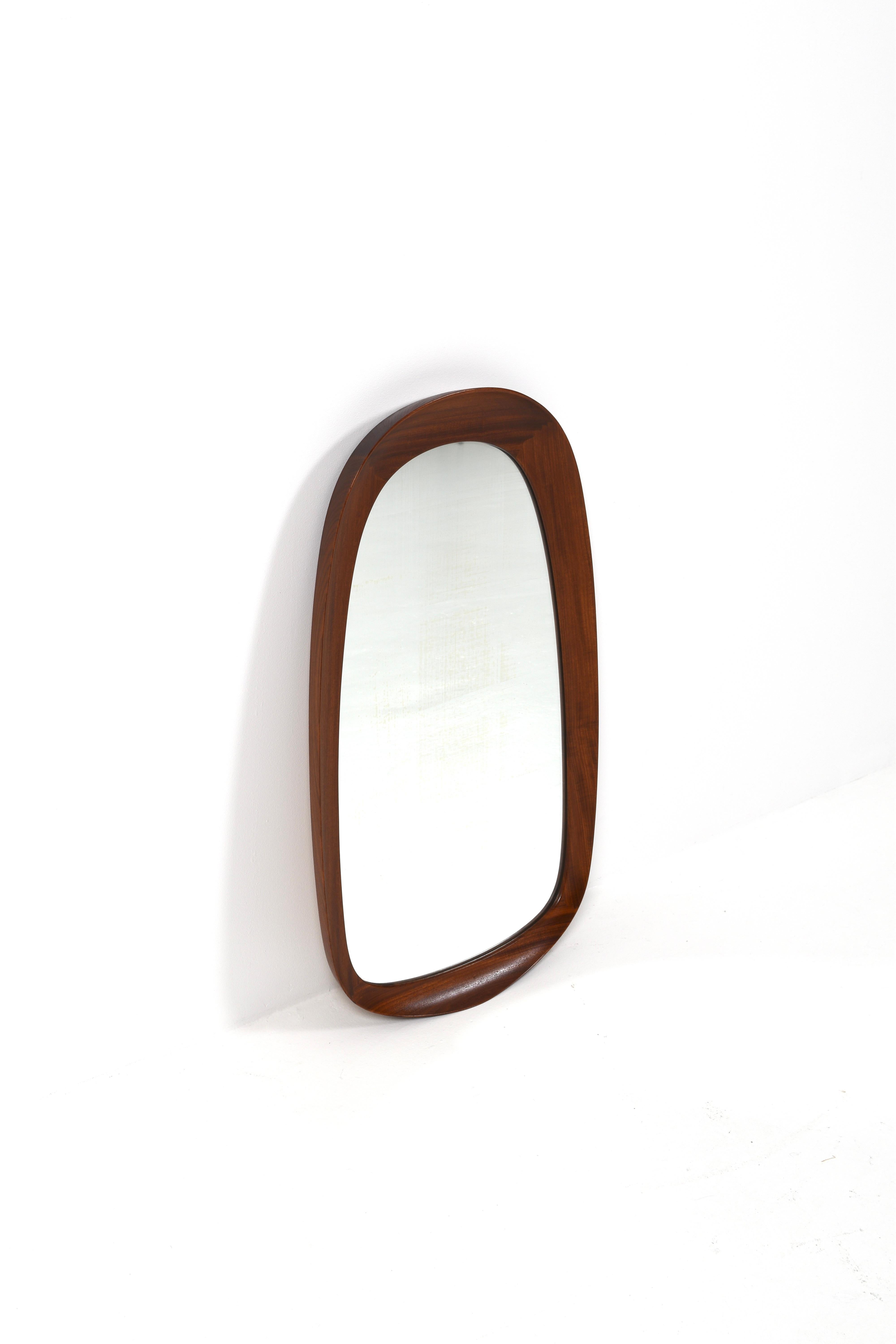 This elegant mid-century wall mirror was produced by Glas & Trä in Sweden during the 1950s. It features a finely crafted solid teak frame with softly rounded corners and a slim, minimalist profile that reflects the clean lines of Scandinavian modern