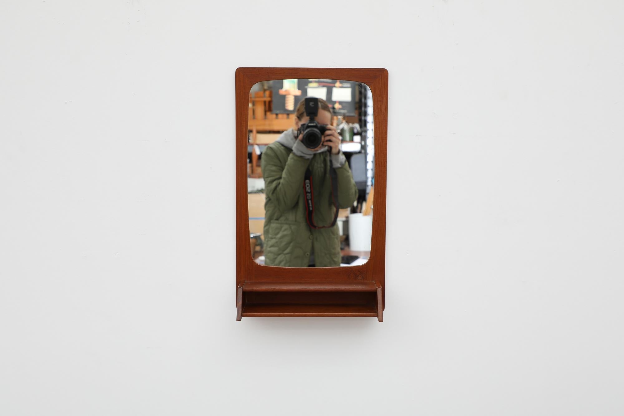 Handsome 1950s or 1960s Danish Wall Mount Teak Mirror with Small Cubby Shelf. Good Original Condition.