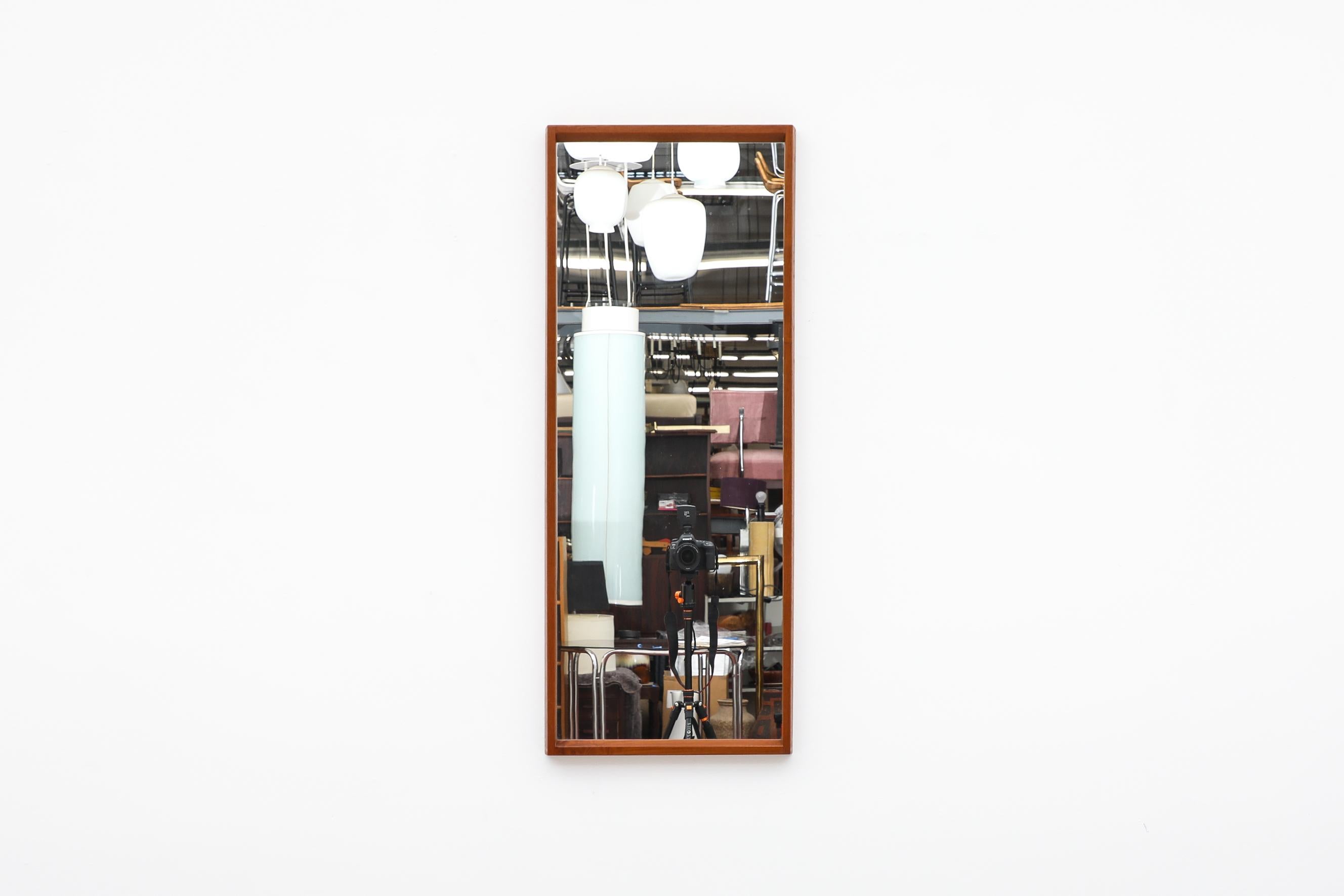 Midcenury teak wall mount mirror designed by Aksel Kjersgaard for Odder. Joints have a handsome peg detail. In original condition with visible wear consistent with its age and use.