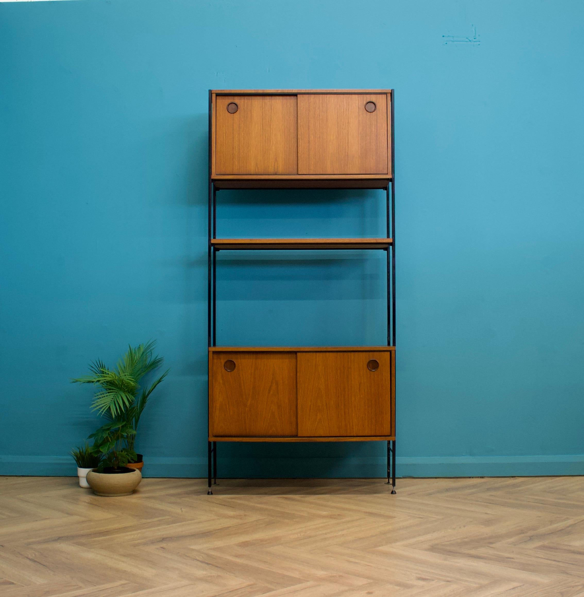 Mid-century modern teak shelving unit from Avalon - circa 1960s

Featuring two sliding door units and a shelf - this piece is modular, the individual pieces can be moved to any height or position
