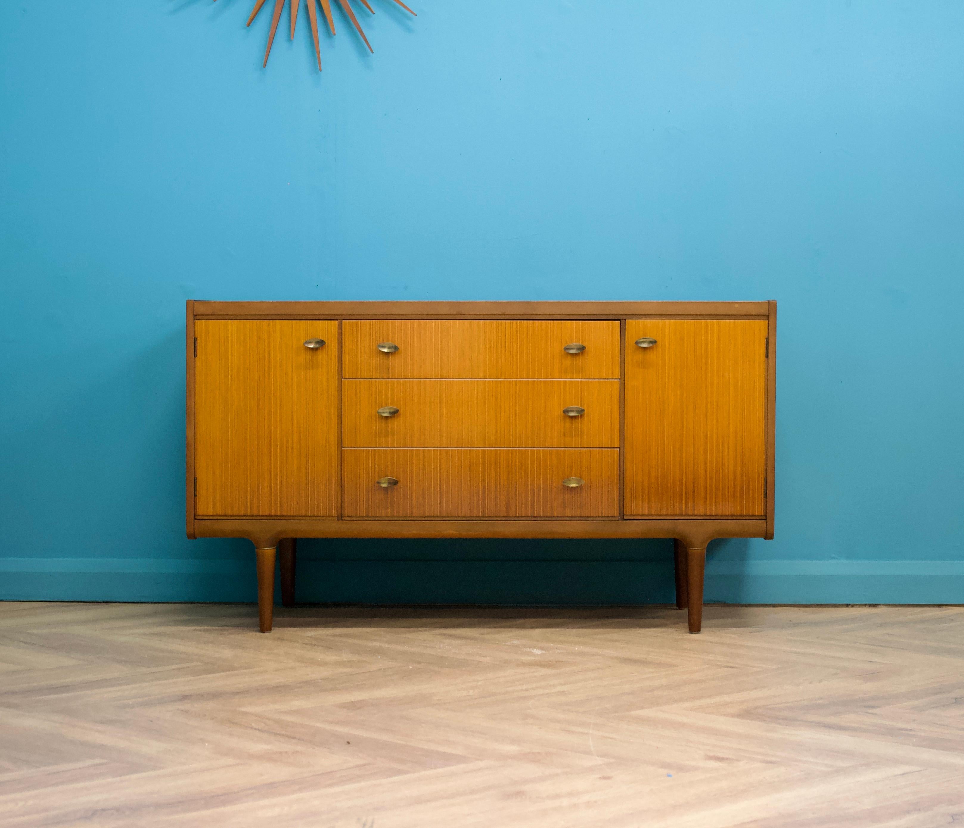A teak & walnut compact sideboard from Wrighton- Circa 1960s

It features three drawers and two cupboards