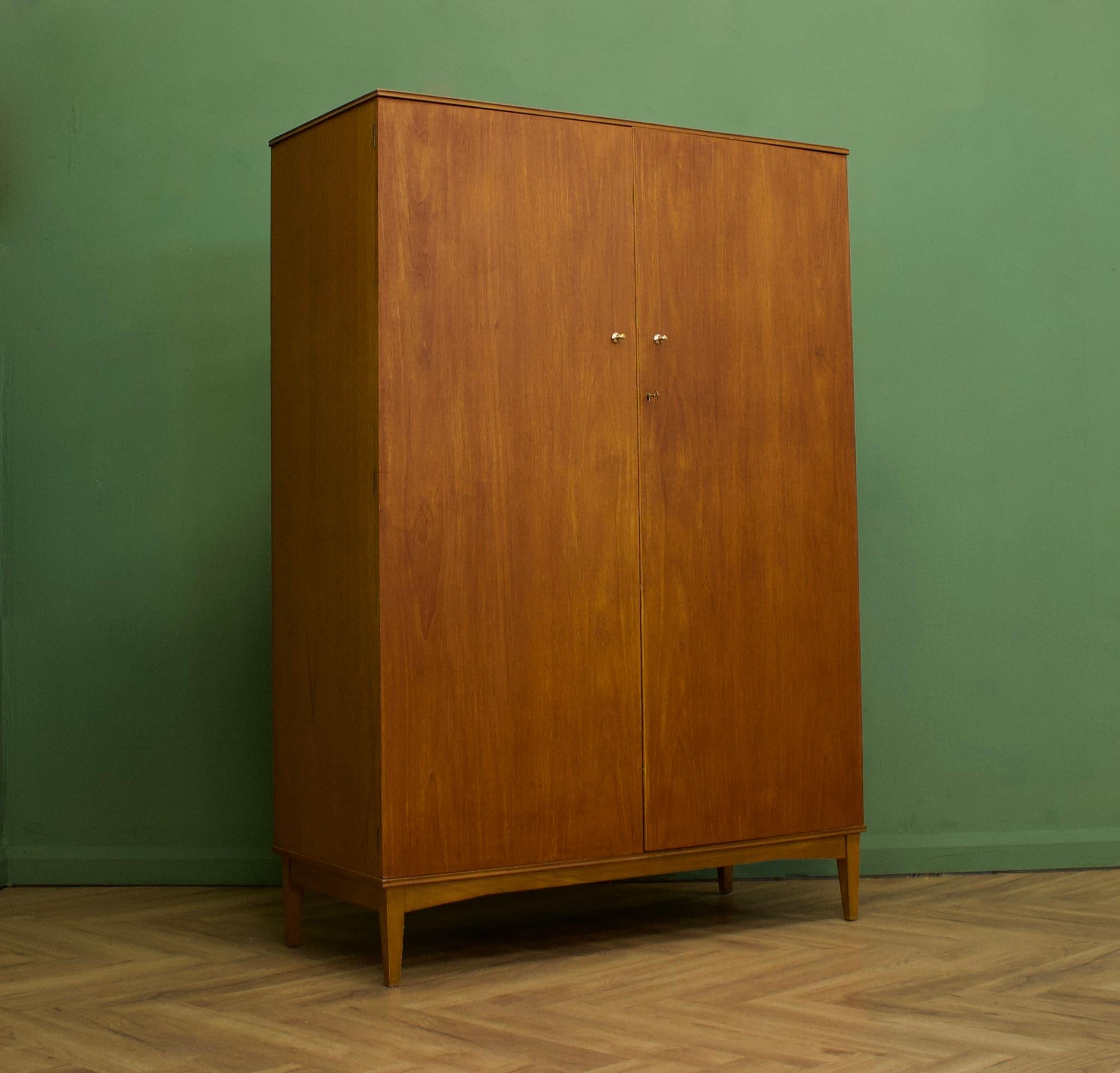 A freestanding double door teak wardrobe in the Danish modern style
Made during the 1960s


Fitted out with two clothes rails and a shelf