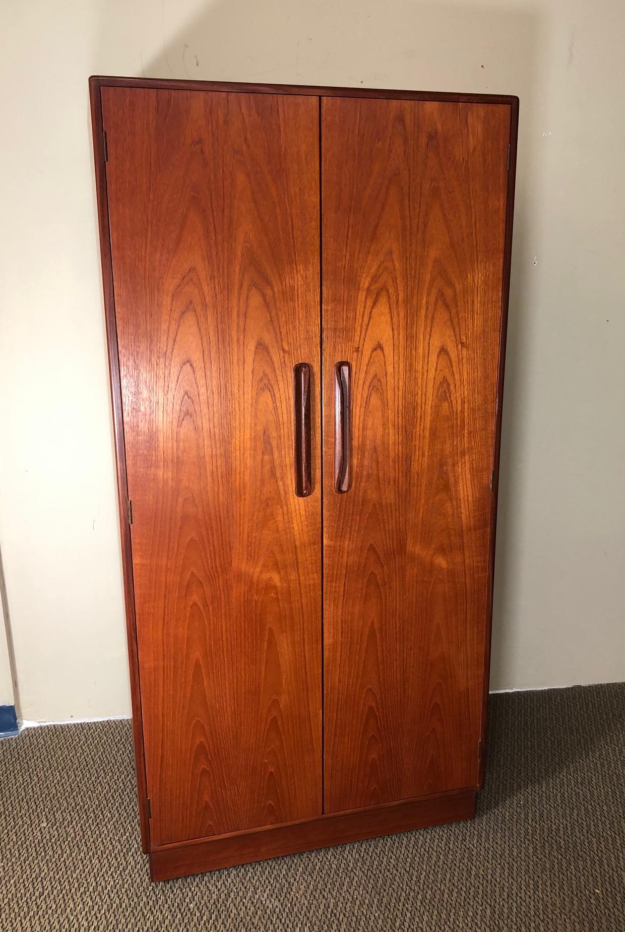 Amazing teak wardrobe by G Plan. Designed in the 1960s by Victor Bramwell Wilkins for G Plan's Fresco Range. Danish Modern in style.
Two door wardrobe with half hanging space on the left side and shelves and drawer space on the right. Top drawer