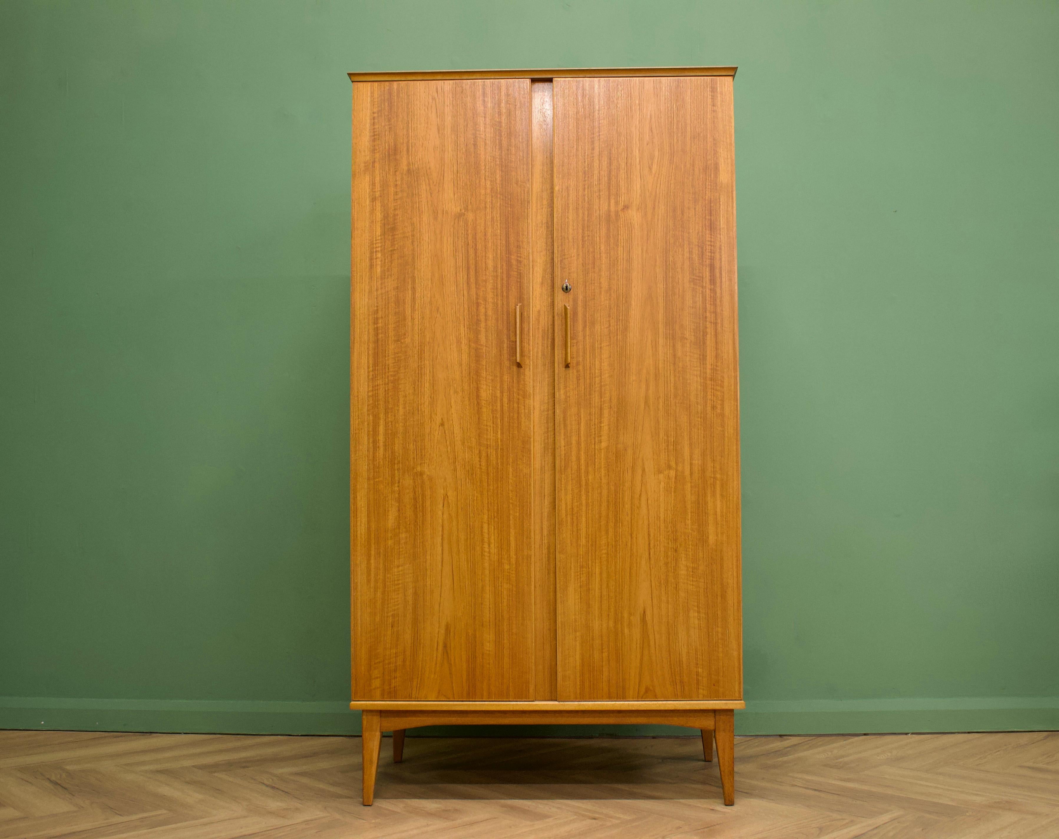 - Mid-Century Modern wardrobe
- Manufactured by Alfred Cox in the UK 
- Retailed through Heal's during the 1960s
- Made from Teak & Teak Veneer
- Featuring two hanging rails, a drawer and shelves.