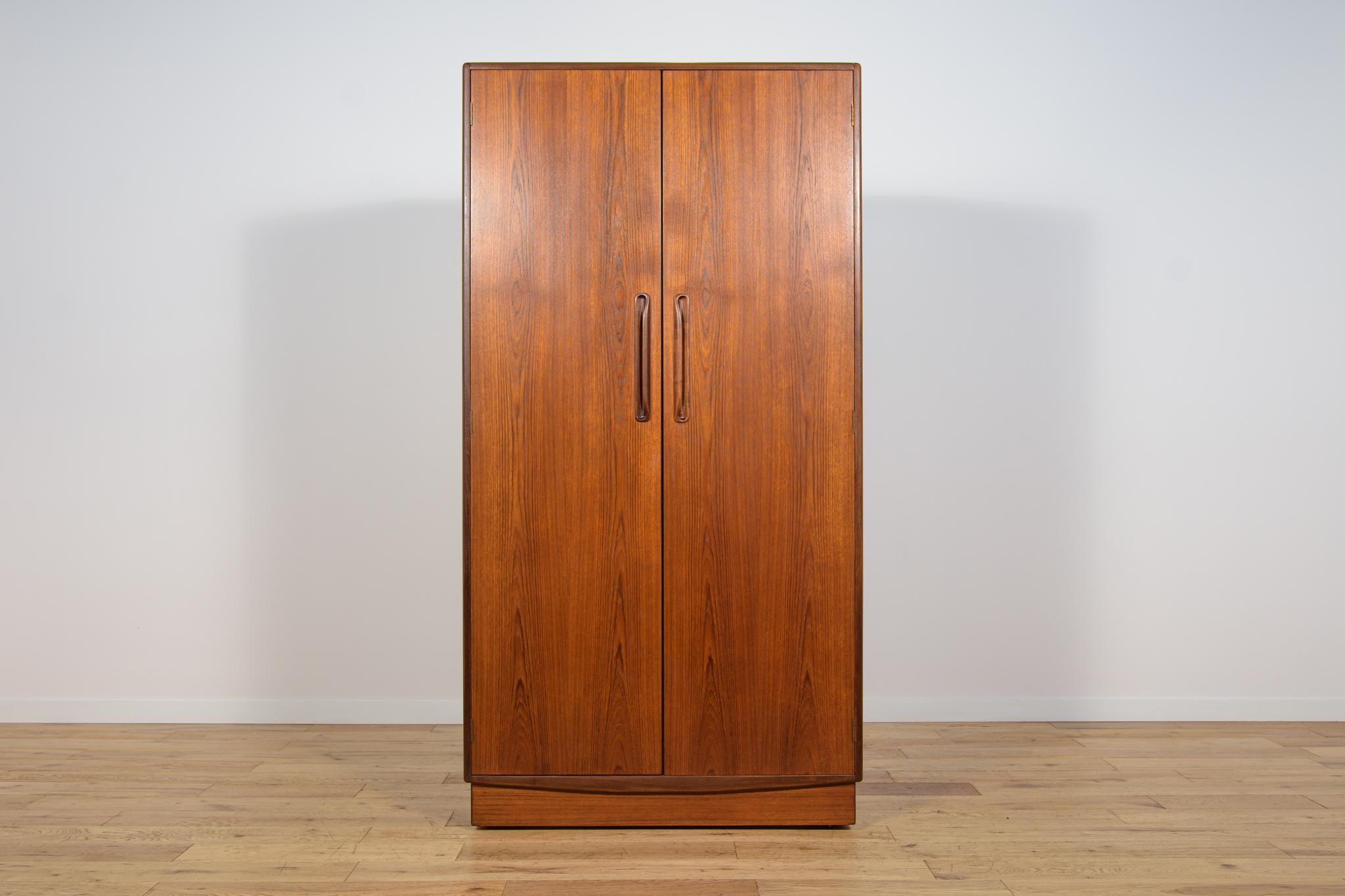 This mid century wardrobe in teak was produced in Great Britain by G Plan in the 1960s. Wardrobe with two doors, inside there are: handrail. The teak elements have been cleaned cleaned of old coating and finished very quality with Danish oil.