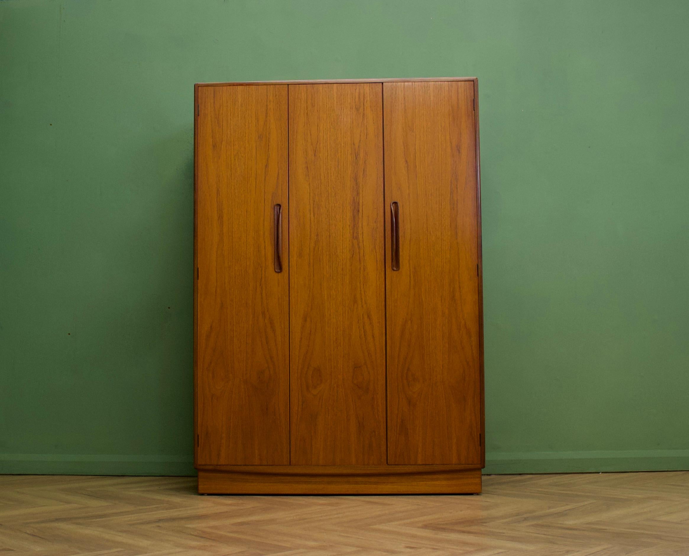 A freestanding triple door teak wardrobe from G Plan from the Fresco range - circa 1970s


Fitted out with a clothes rail , shelves and drawers
The style of this wardrobe is minimalist - with it's clean lines


The matching three door wardrobe is