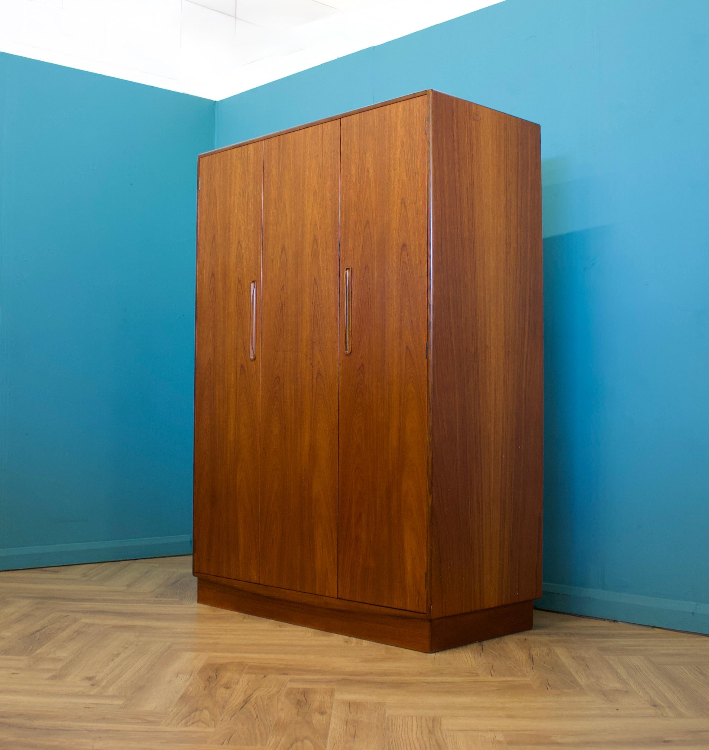 A freestanding triple door teak wardrobe from G Plan from the Fresco range - circa 1970s


Fitted out with a clothes rail the full width
The style of this wardrobe is minimalist - with it's clean lines


This wardrobe will flat pack