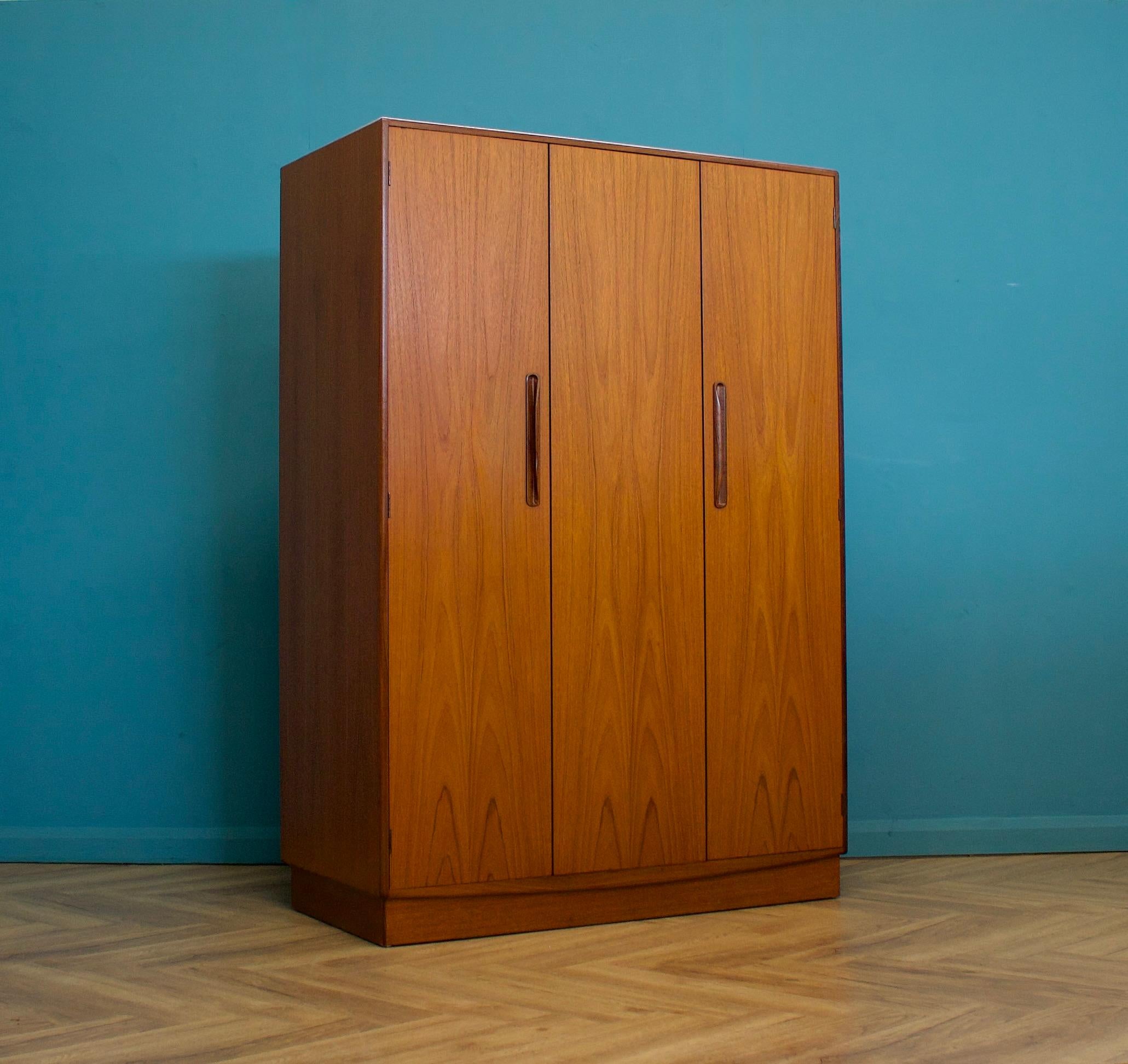 A freestanding triple door teak wardrobe from G Plan from the Fresco range - circa 1970s


Fitted out with a clothes rail the full width
The style of this wardrobe is minimalist - with it's clean lines


This wardrobe will flat pack