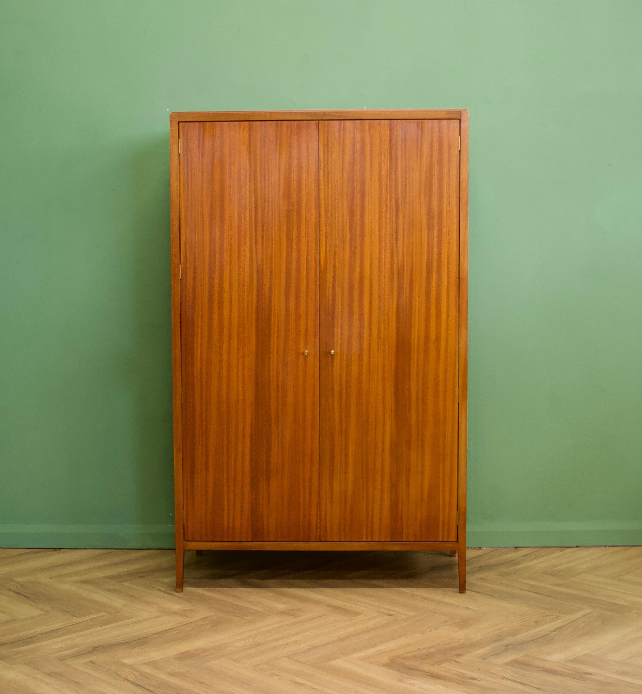 A beautiful quality, mid century mahogany & teak wardrobe from Loughborough Furniture - retailed through Heals during the 1950's - early 1960's - and designed by Neville Ward and Frank Austin


Standing on slightly tapered legs, like the overall