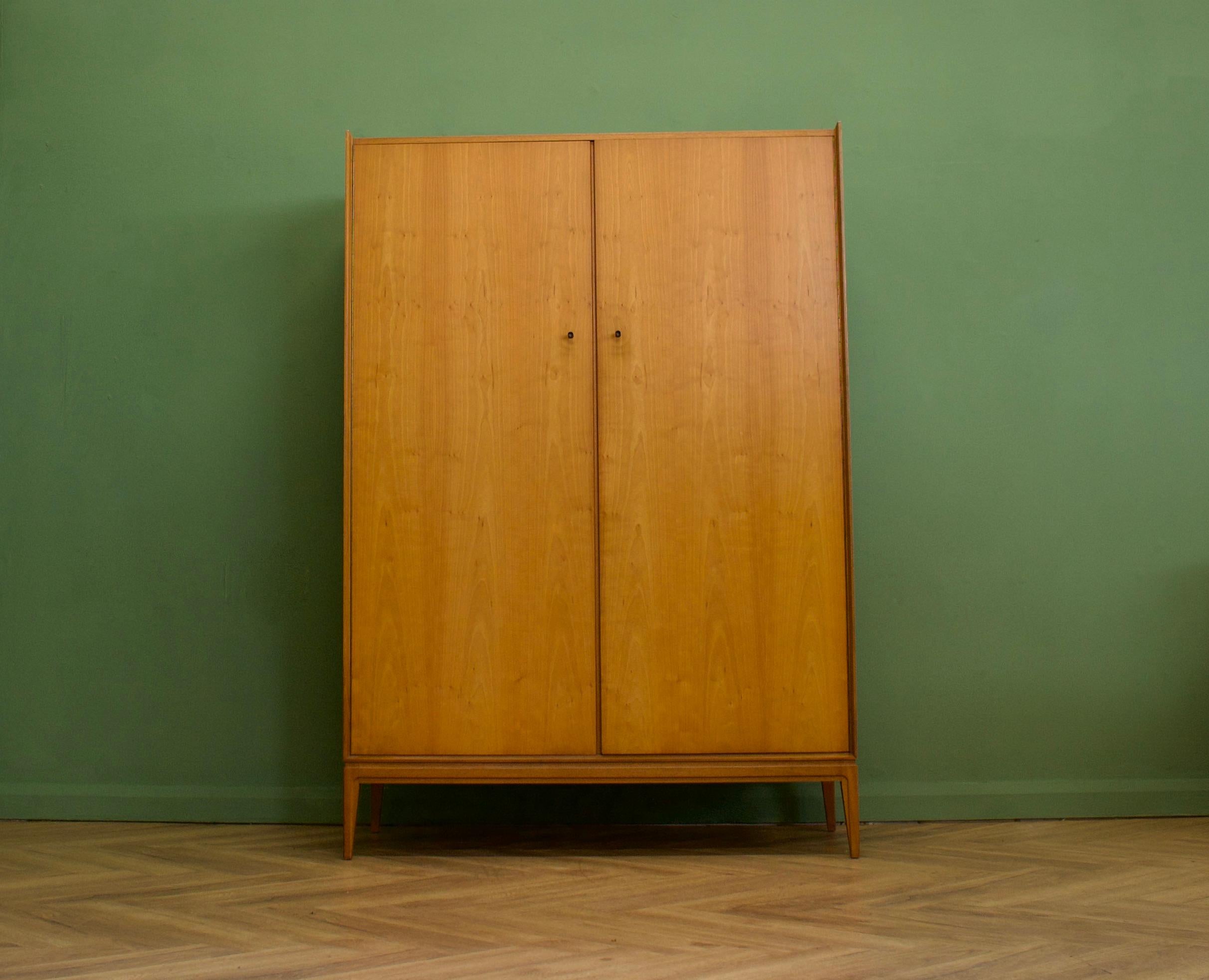 A freestanding double door teak wardrobe from McIntosh - in the Danish modern style
Made during the 1960s

Fitted out with a clothes rail and fixed shelving for ample storage in such a compact piece
The style of this wardrobe is quite minimalist -