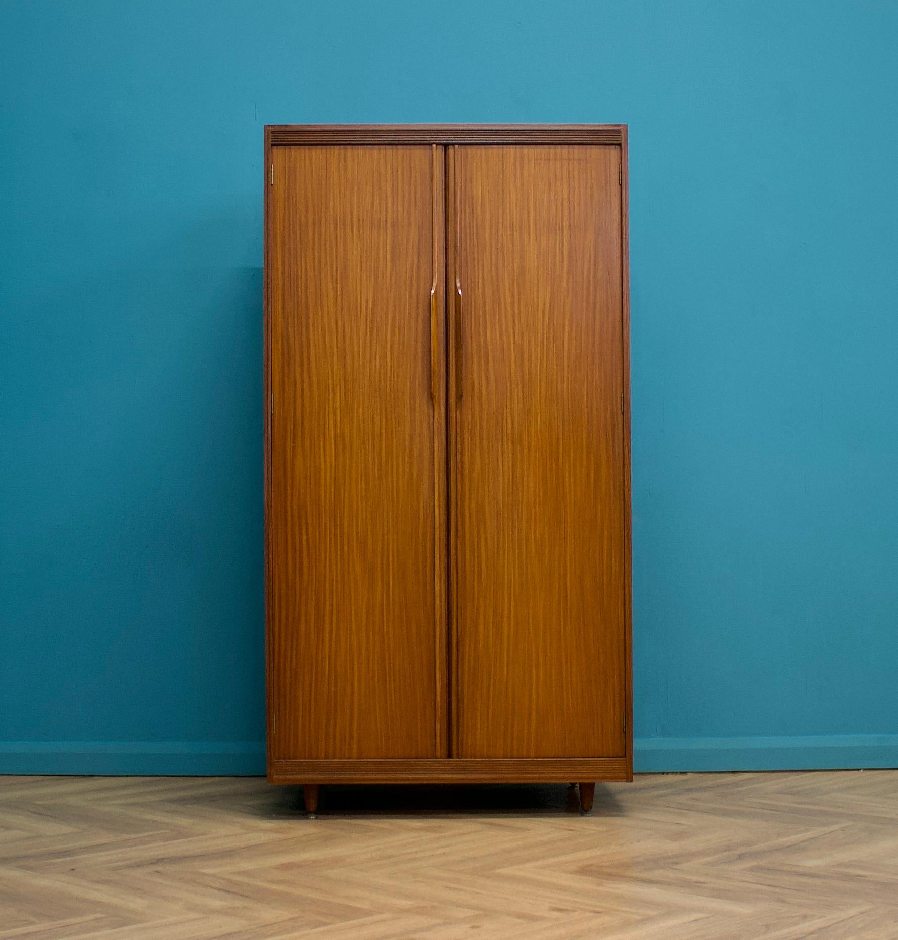 A freestanding double door teak wardrobe from White & Newton-  in the Danish modern style
Made during the 1960s


Fitted out with a clothes rail, drawers, a compartment and shelving for ample storage in such a compact piece
The style of this
