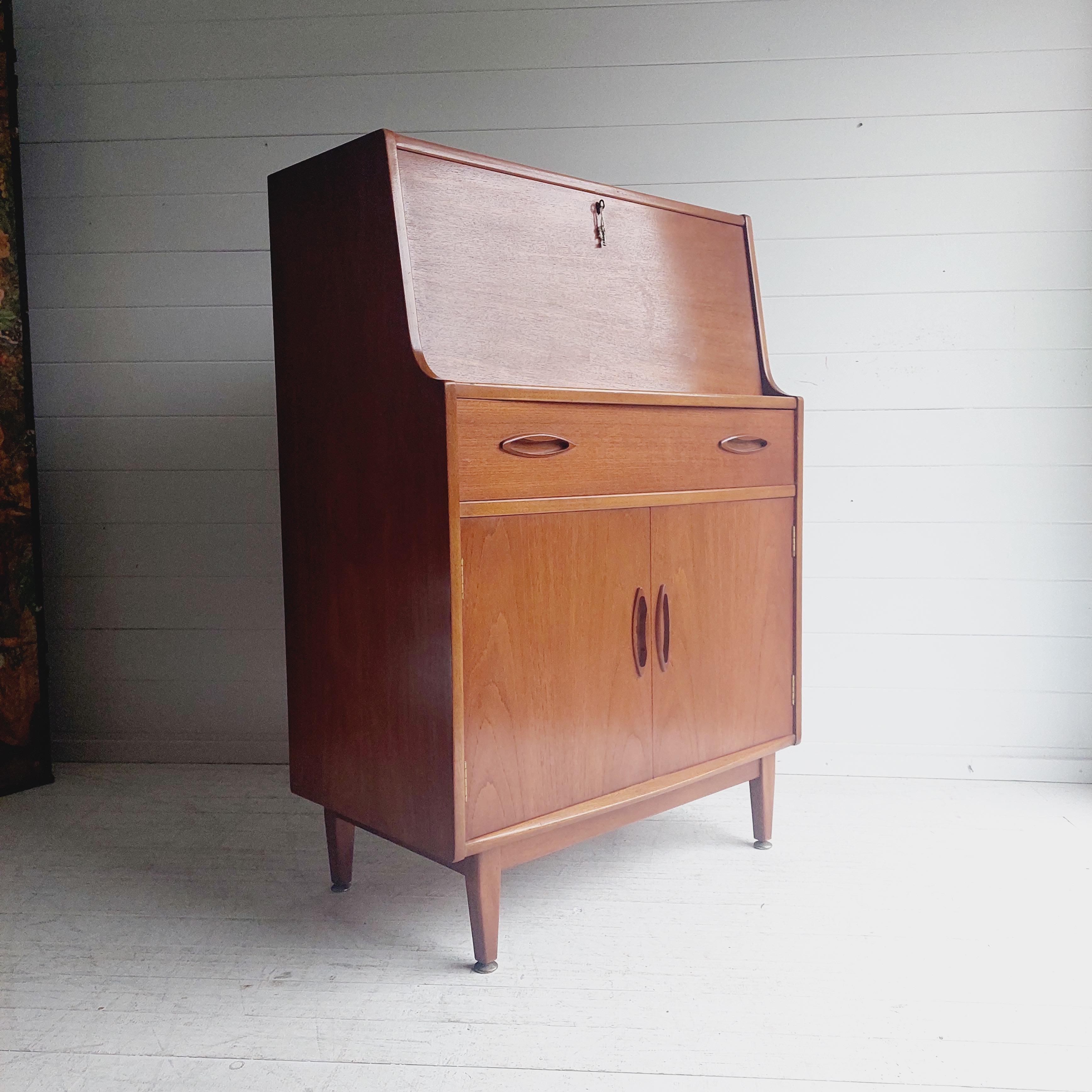 Mid Century Jentique Teak Bureau Secretaries Desk.
Designed and made in the 1960s, this Bureau is an extremely rare and collectible item, but more importantly is a stunning piece that immediately adds mid century elegance to any room.

A stunning