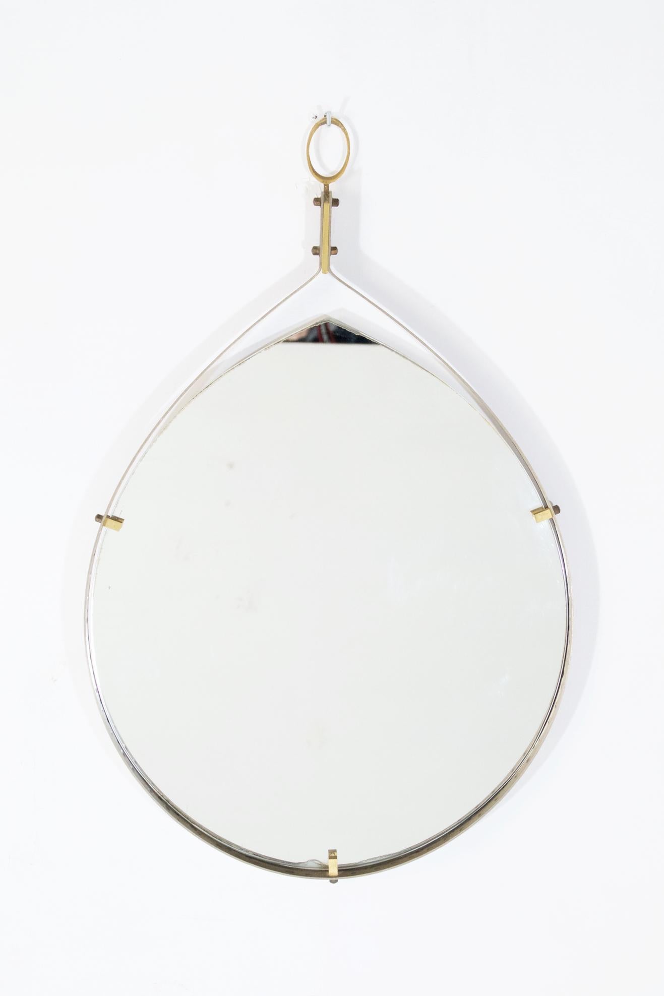 Handmade artisanal drop shaped mirror set in an iron frame with brass hardware details. Original sticker from Mobilificio Fiorentini, Bologna Italy. In good overall condition.