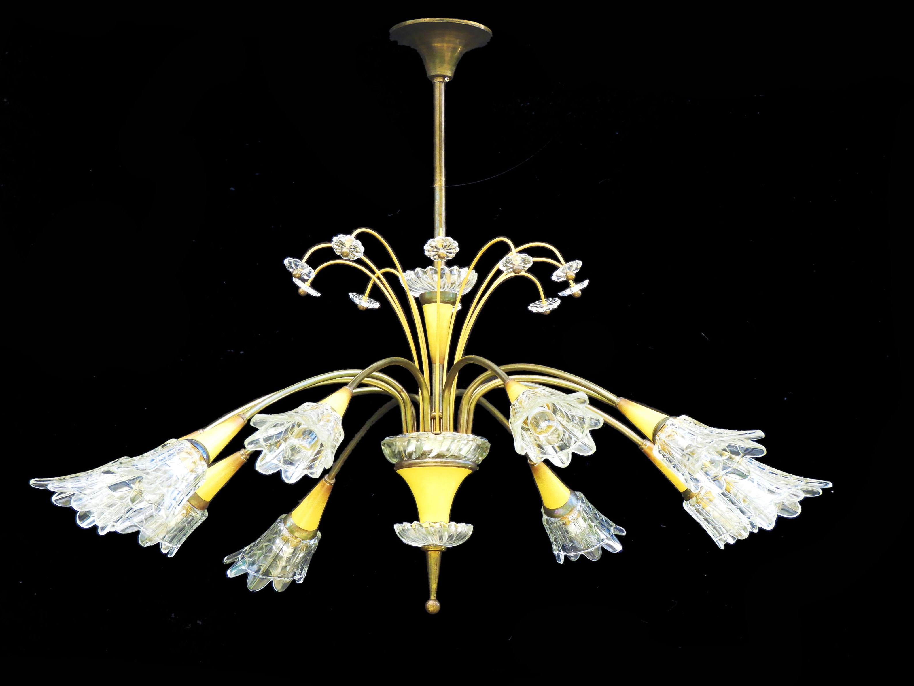 Mid-century ten light chandelier by Maison Lunel circa 1950 France

Fabulous ten-light chandelier from French lighting manufacturer Maison Lunel.
Ten brass stems sloping outwards towards the golden yellow tôle flowers and textured glass tulips