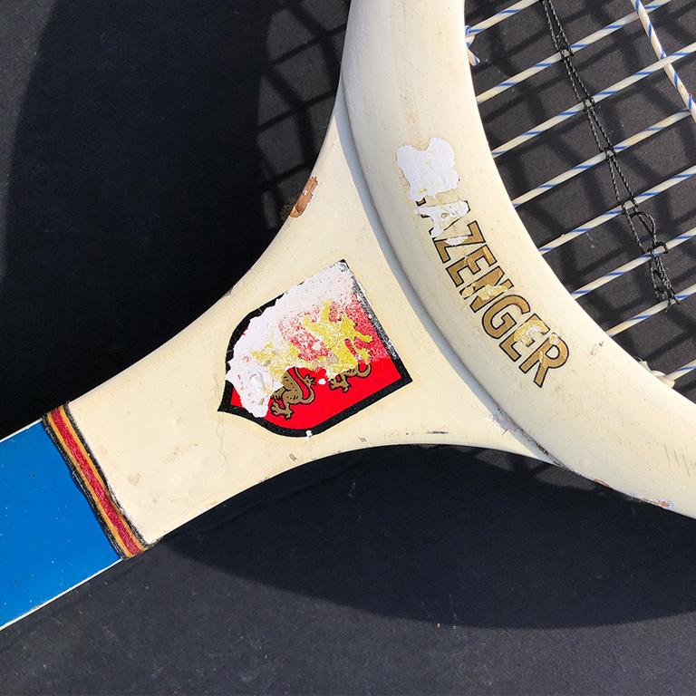 Midcentury tennis racket by Slazenger. Wood frame, and woven string in the middle. The piece features red, white and blue coloring. The handle is wrapped in tennis tape. It would be a beautiful piece on a wall or in a child's room or man cave.
