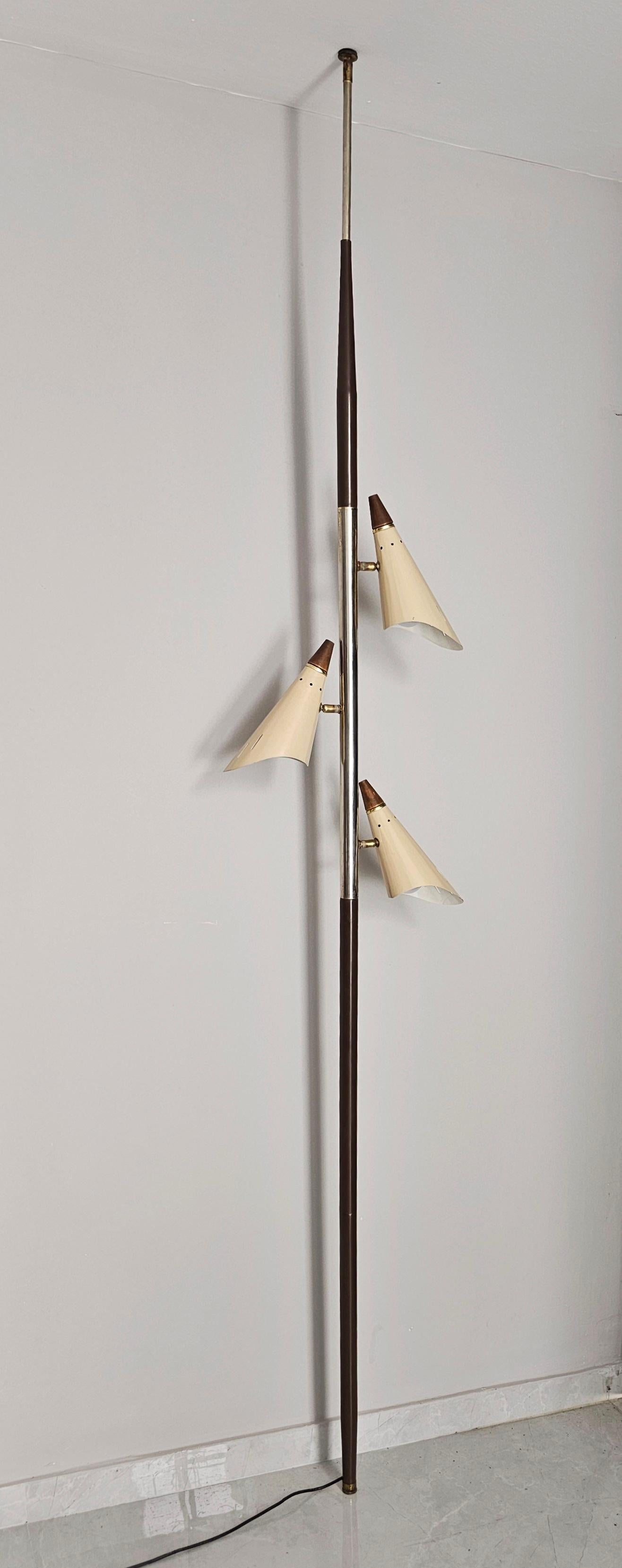 In this listing you will find an exceptionally rare Mid Century Modern Tension Pole Lamp with 3 adjustable shades. Manufacturing of the lamp is attributed to Stilnovo. The lamp is done in nickel plated brass and steel, with teak tops on each shade