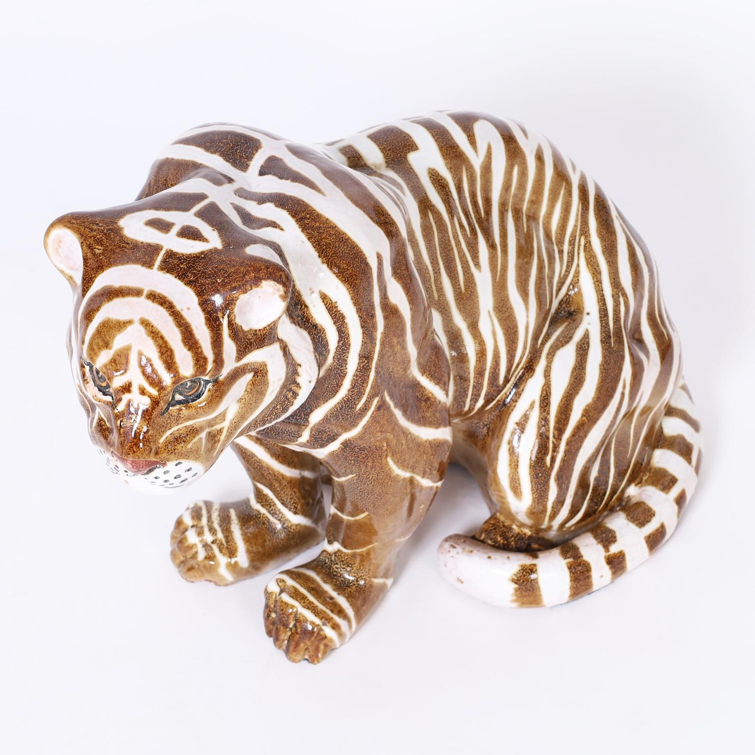 Mid century tiger sculpture or object of art crafted in terra cotta, decorated with brown and white stripes and glazed.