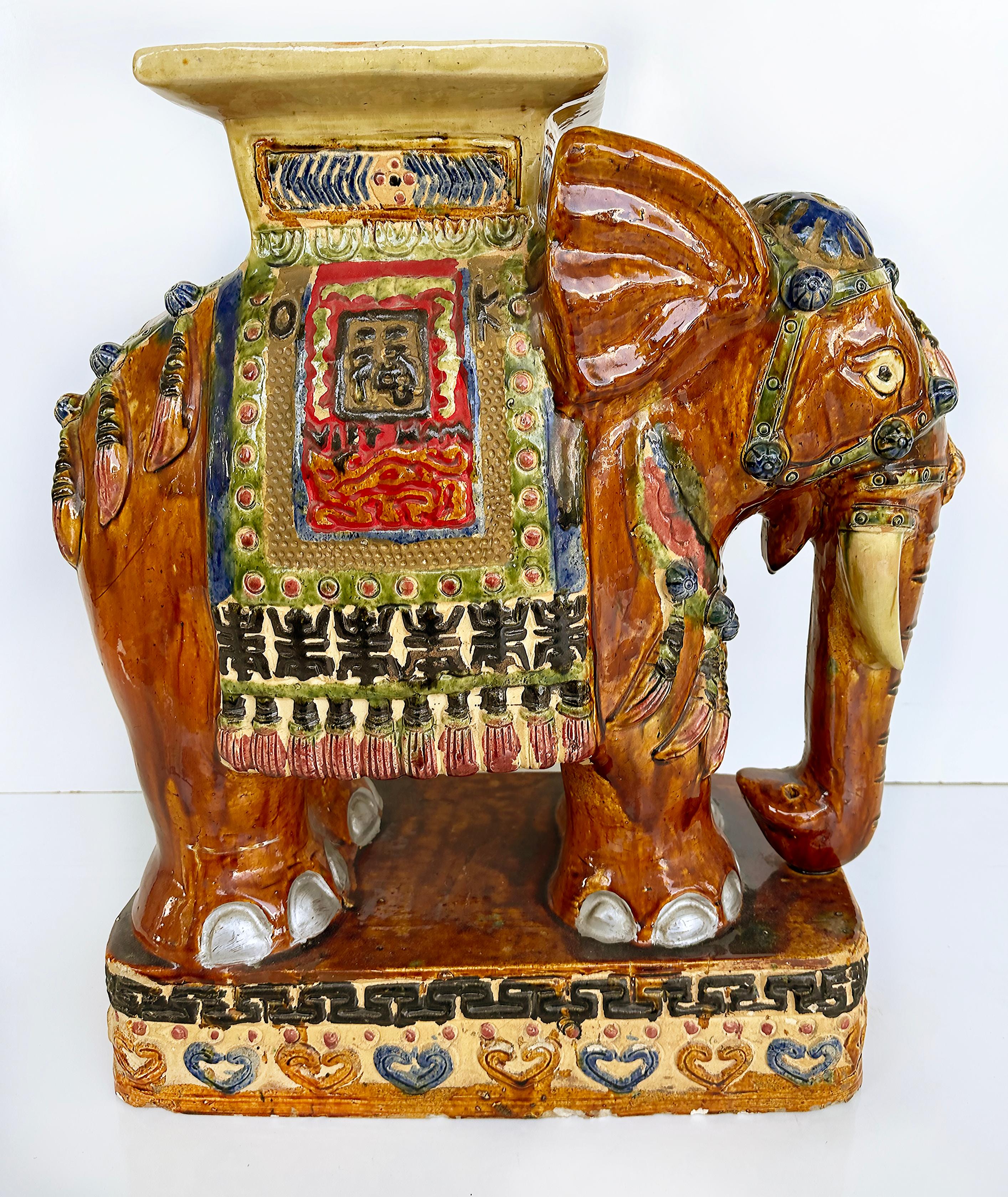 Mid-century Terracotta Elephant Garden Stool Drinks Table Plant Stand

Offered for sale is a mid-century hand-painted and glazed elephant garden stool that will make a charming drinks table or plant stand. The garden stool has imperfections on one