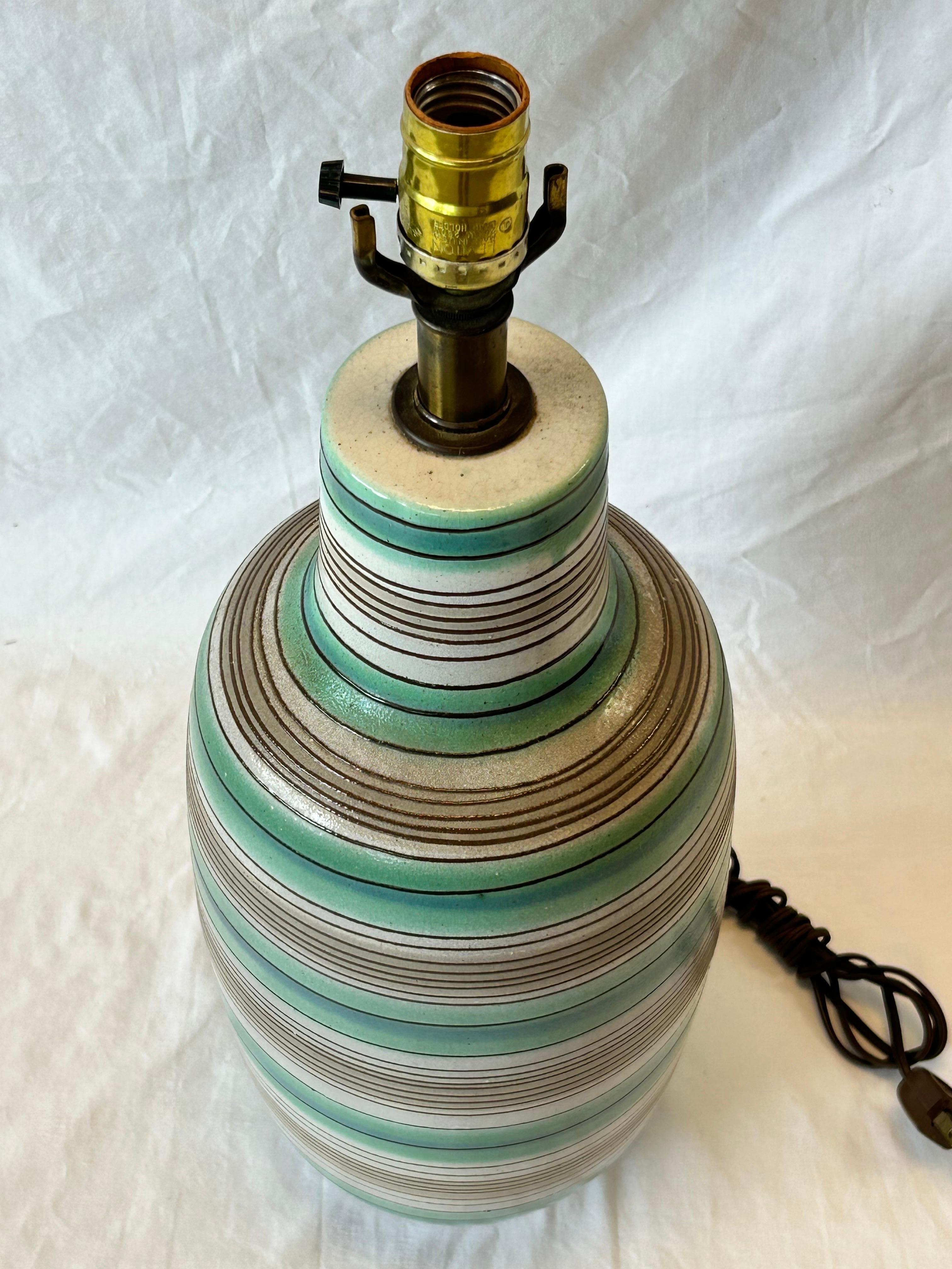 A mid century modern era, circa 1960's glazed terra cotta table lamp with a hand painted glazed stripe design, probably of Italian origin. This form and design have been attributed to being in the style of Lee Rosen / Design Technics. This gorgeous
