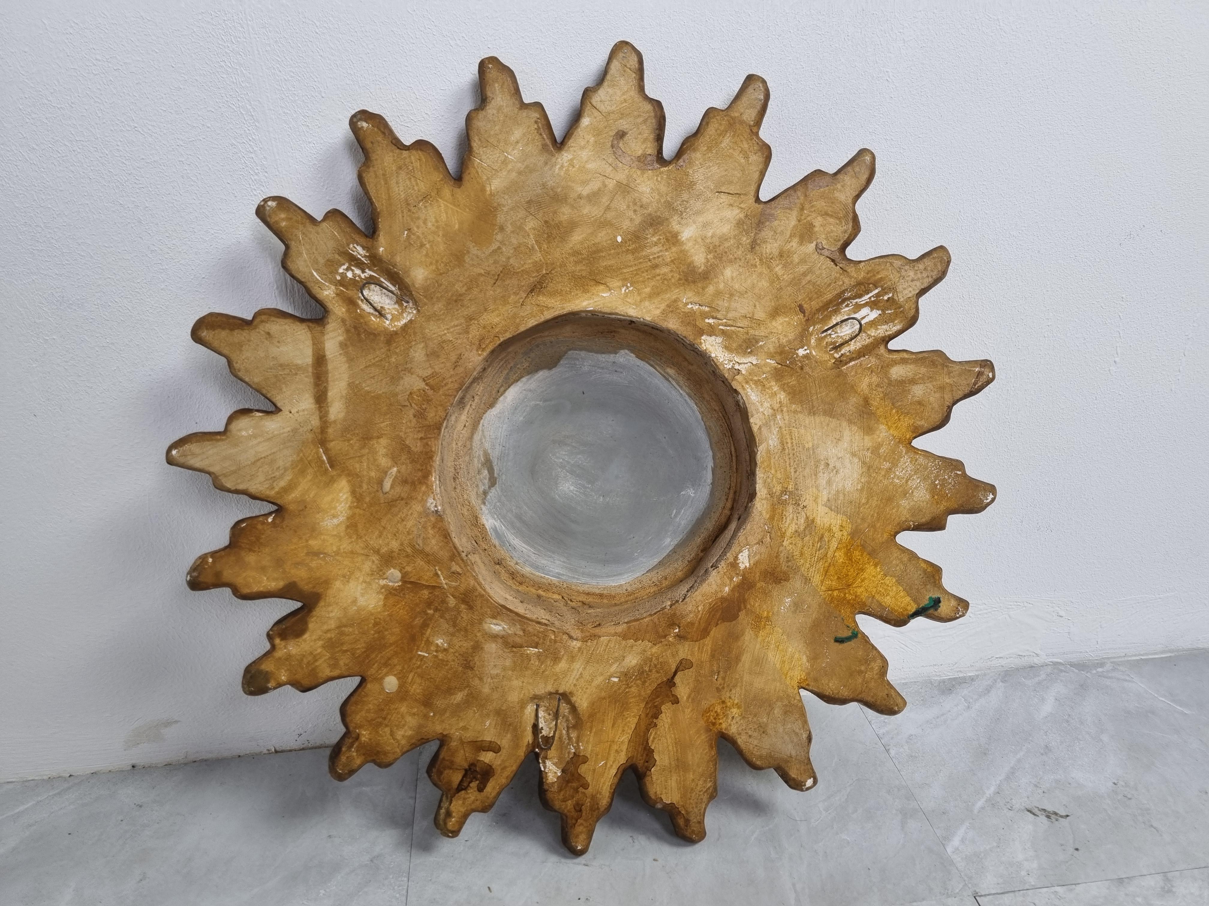 Rare terracotta sunburst mirror with a convex mirror glass.

The mirror is in a good vintage condition.

1960s - Belgium

Dimensions:

Diameter: 42cm/16.53