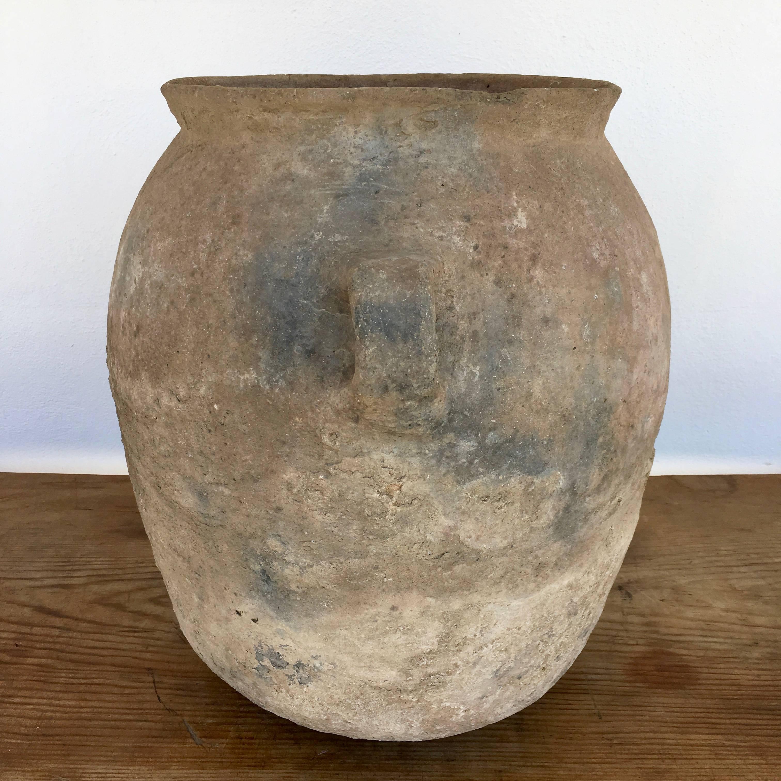 Mid-century terracotta or clay water vessel with nicely worn patina from Los Reyes Metzontla, Puebla. The design is a slight variation of the typical pottery found in this area. The pot's weight, age and style offer testimony to the age of this